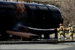 U.S. Airmen assigned to the North Carolina Air National Guard (NCANG), 145th Civil Engineering Squadron (CES), attempt to extinguish a fire during a simulated aircraft mishap just outside the NCANG base, Charlotte Douglas International Airport, March 6, 2022. The 145th CES coordinated the response with the Charlotte Fire Department and other local authorities.