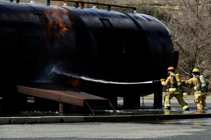 U.S. Airmen assigned to the North Carolina Air National Guard (NCANG), 145th Civil Engineering Squadron (CES), attempt to extinguish a fire during a simulated aircraft mishap just outside the NCANG base, Charlotte Douglas International Airport, March 6, 2022. The 145th CES coordinated the response with the Charlotte Fire Department and other local authorities.