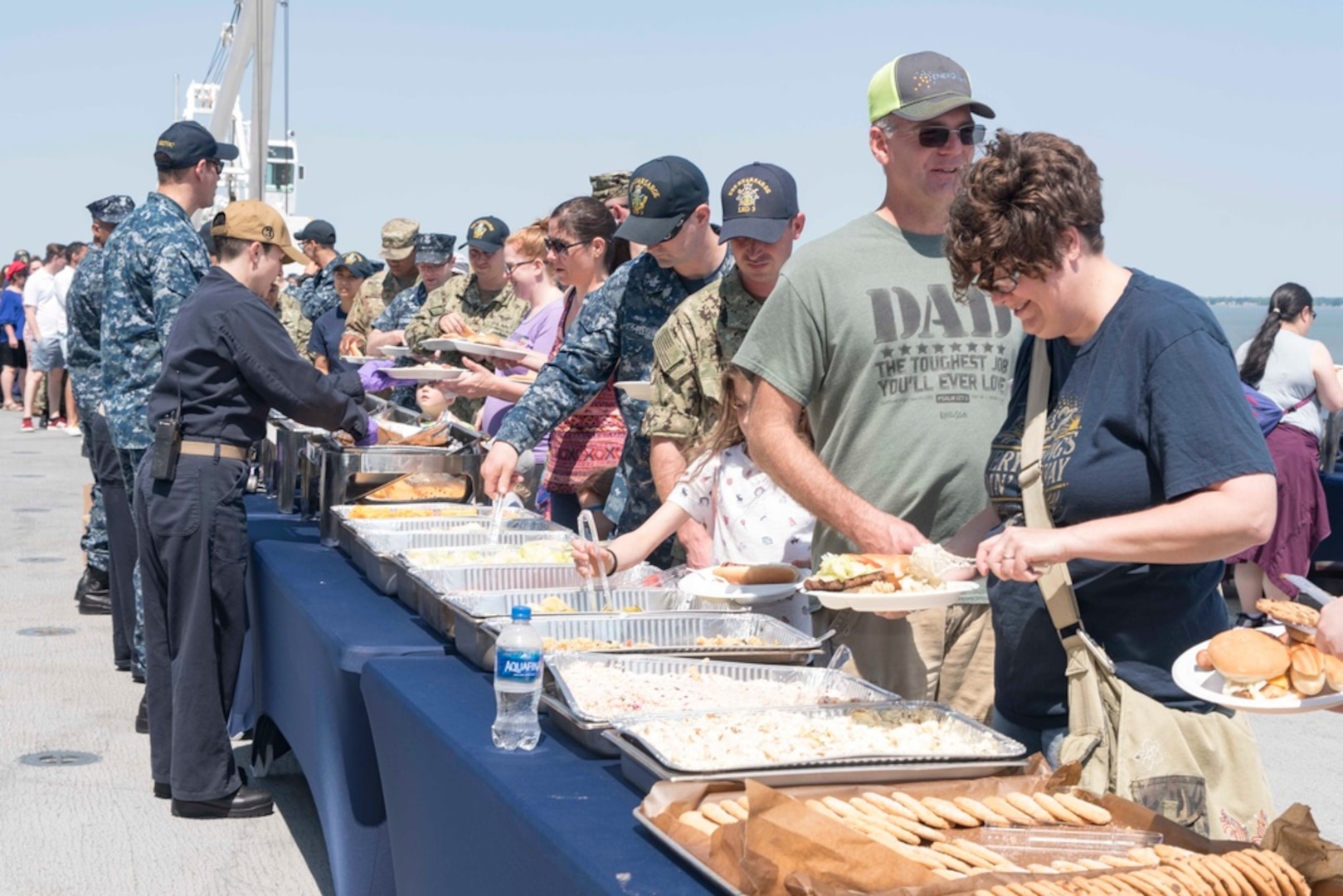 Sailors assigned to the Wasp-class amphibious assault ship USS Kearsarge (LHD 3) serve food during a Friends and Family Day event hosted aboard Kearsarge. The officers and crew of Kearsarge hosted a Friends and Family Day event to display their operational capabilities to their loved ones. (U.S. Navy Photo by MC3 Kaitlyn E. Eads/Released)