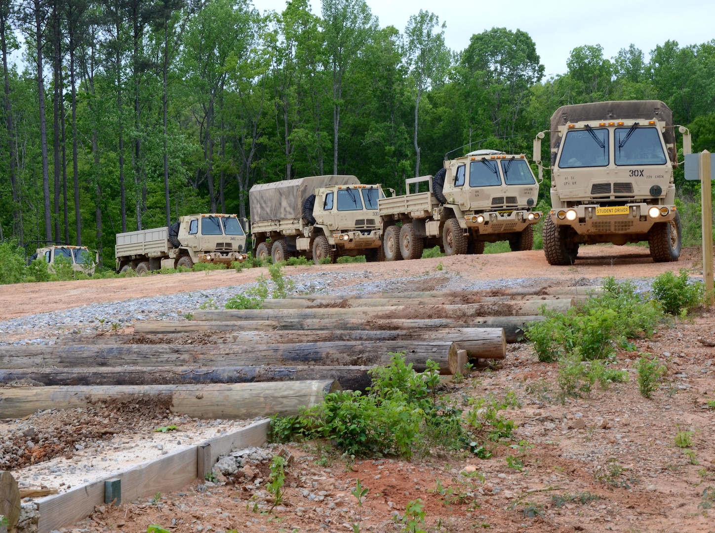 Cadre assigned to the Fort Pickett-based 2nd Battalion, 183rd Regiment, Regional Training Institute guide National Guard Soldiers from several states through the Beaver Trail Wheeled Vehicle Obstacle Course during the 15-day 88M motor transport operator course April 29, 2019, at Fort Pickett, Virginia. The students drove medium tactical vehicles through multiple obstacles simulating challenging terrain including ditches, steep declines, steep inclines, rocky and uneven terrain, learning how to handle the vehicles and negotiate difficult driving conditions. (U.S. National Guard photo by Mike Vrabel)