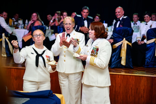 Beth Lambert, woman in her white uniform joins sailors at ceremony