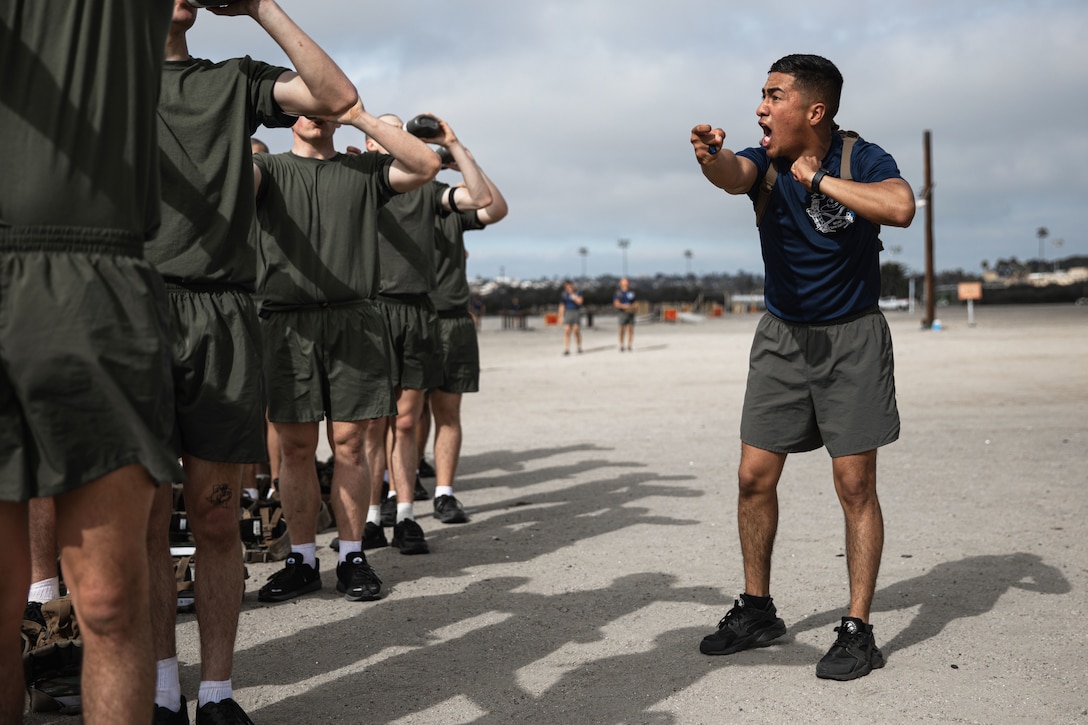 A man shouts at a group of other men.