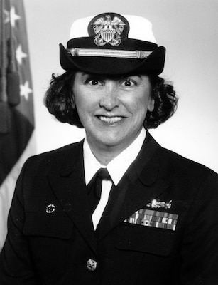 Black white official portrait of woman in her uniform smiling