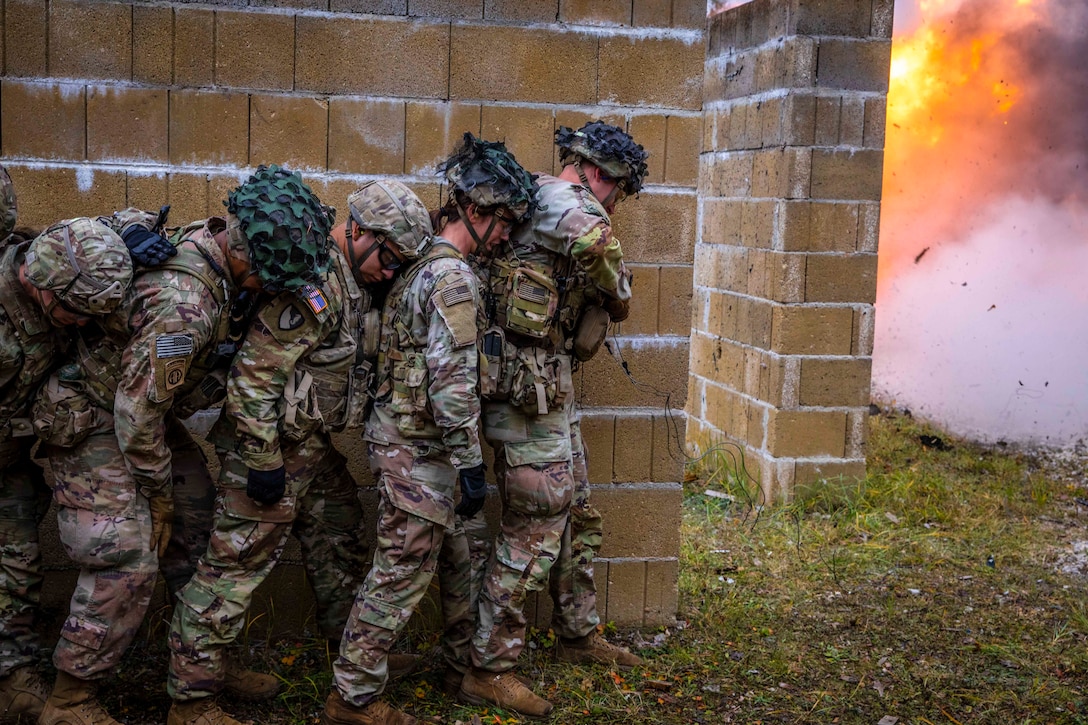 Students in the Combined Arms Training Center's Urban Breach Course are stacked to prepare breaching a concrete wall destroyed by explosive C-4 charges at Grafenwoehr Training Area, Germany Nov. 3, 2021.