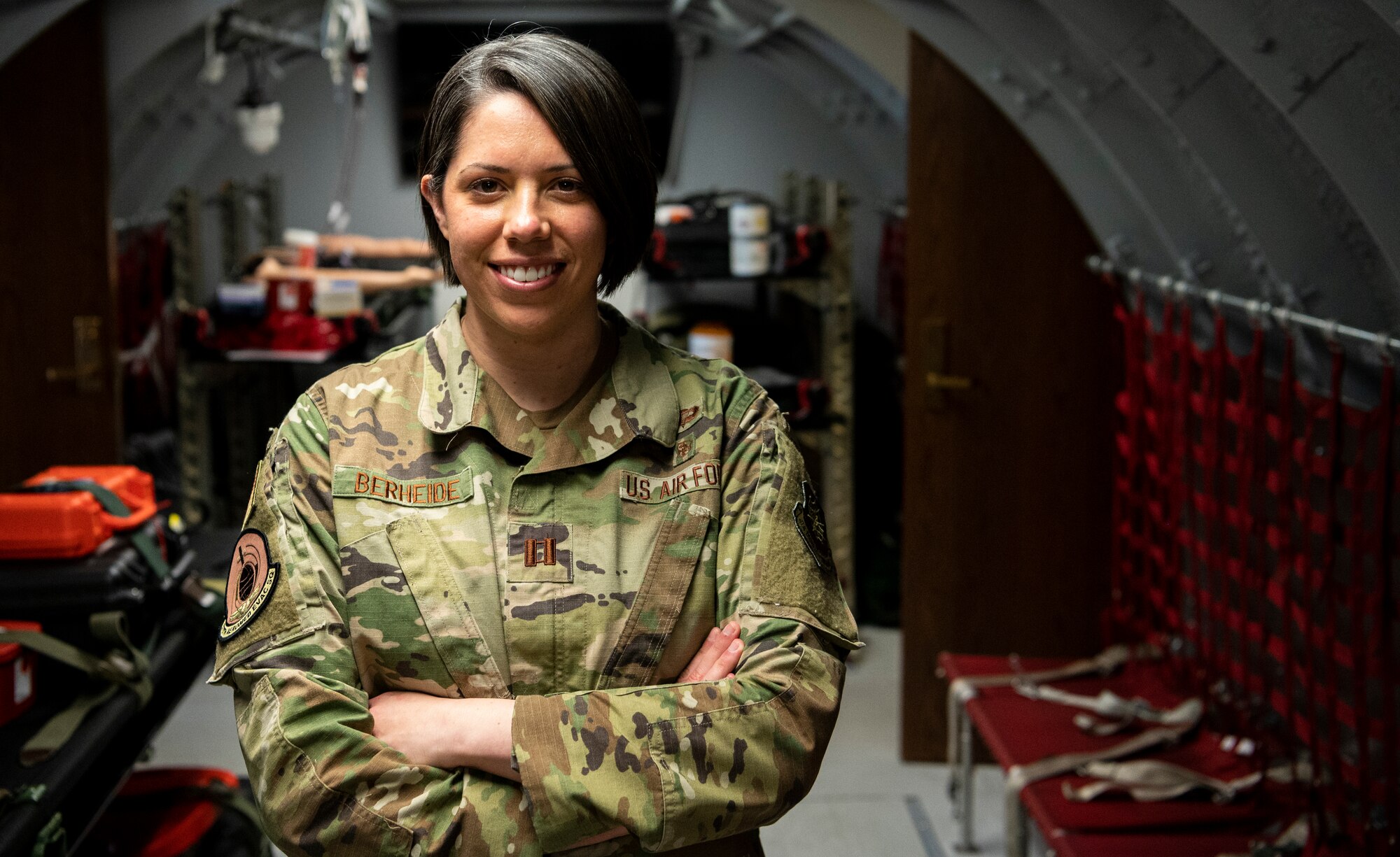 U.S. Air Force Capt. Sarah Berheide, 375th Aeromedical Evacuation Squadron operations support flight commander, stands in a training room at the 375th AES, March 3, 2022 at Scott Air Force Base, Illinois. Berheide is part of the 2019 Women's Initiative Team that brought change to policy for female hair and uniform regulations. (U.S. Air Force photo by Staff Sgt. Solomon Cook)