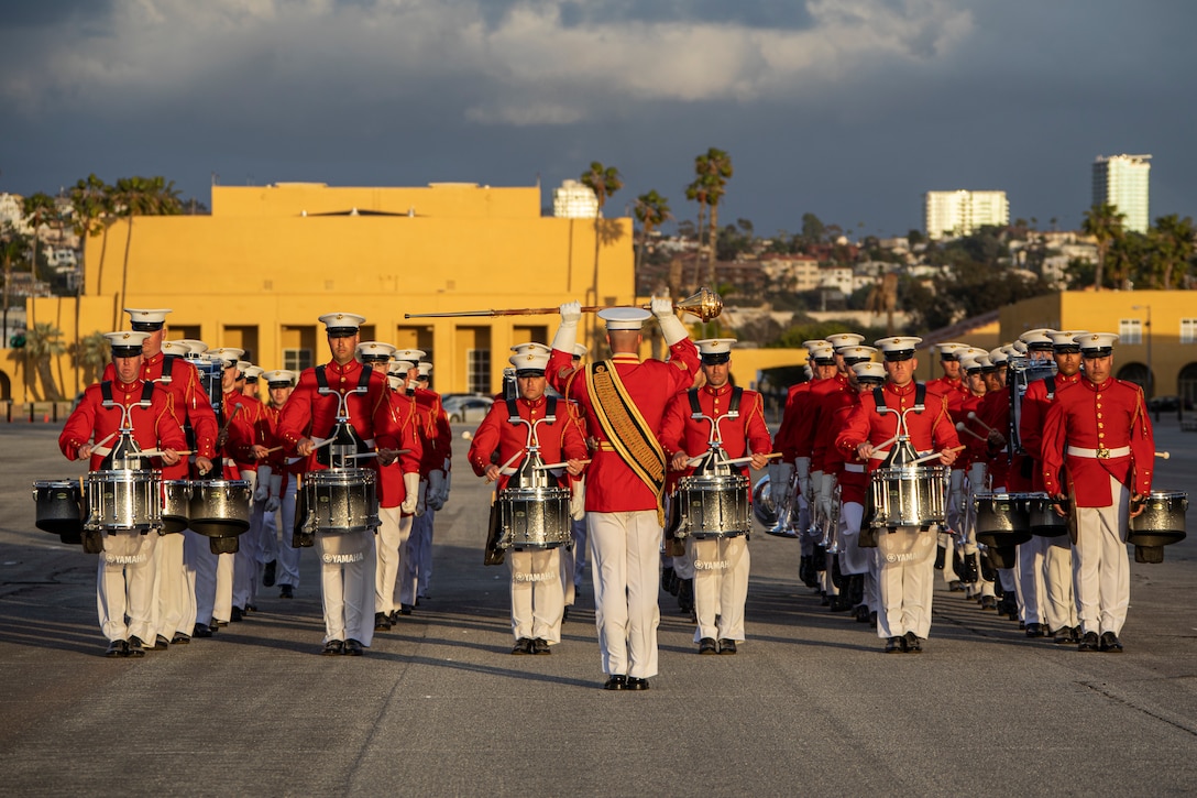 U.S. Marines with Marine Drum and Bugle Corps, Battle Color Detachment, Marine Barracks Washington, D.C., march in formation during the centennial celebration at Marine Corps Recruit Depot San Diego, March 5, 2022. MCRD San Diego celebrated the 100th anniversary of its commissioning by highlighting the Depot’s history and legacy with the assistance of the Marine Corps Battle Color Detachment. The Battle Color Detachment is comprised of three ceremonial units from Marine Barracks Washington, D.C.; the U.S. Drum and Bugle Corps, the Silent Drill Platoon, and the Marine Corps Color Guard.