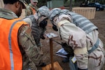 Airmen of the 202nd RED HORSE Squadron perform as members of a post attack reconnaissance team in a contingency exercise during a simulated attack at Camp Blanding Joint Training Center in Starke, Florida. This exercise marked the completion of the squadron's second phase of training before deploying overseas.