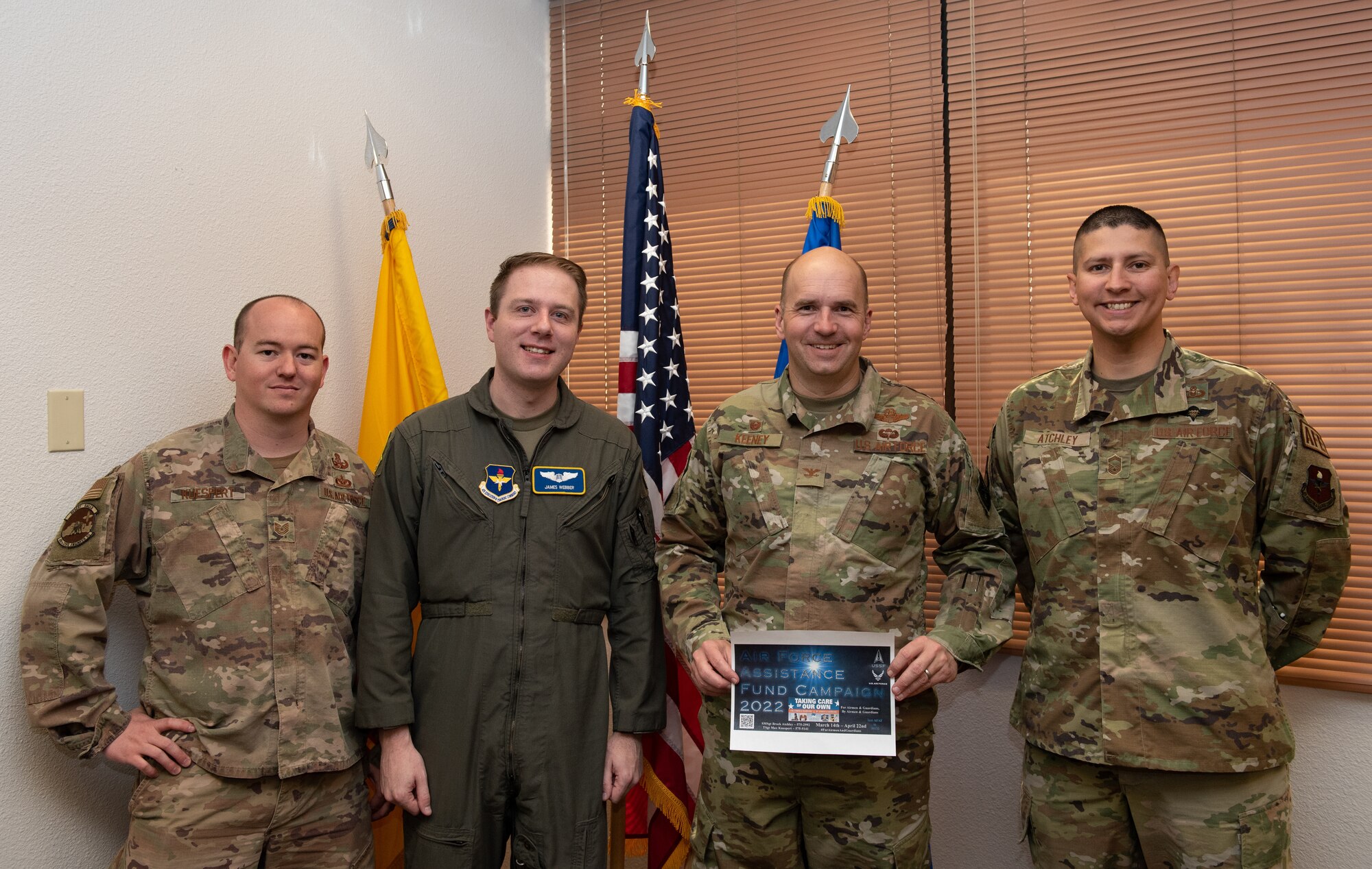 Col. Ryan Keeney and Air Force Assistance Fund representatives pose for a photo.