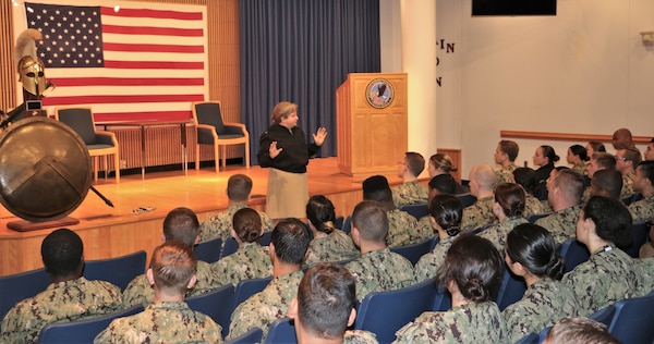 Rear Adm. Danelle Barrett, woman in black suit giving speech at training