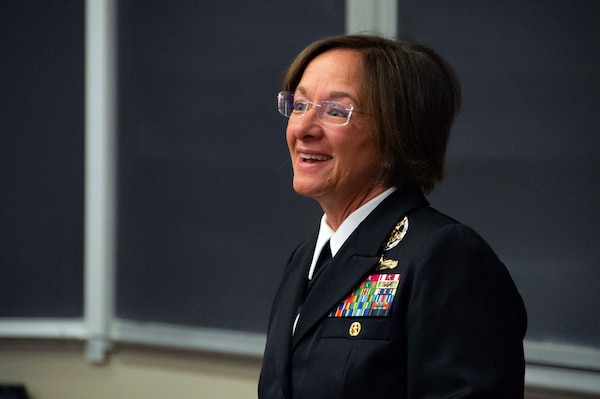 Smiling woman in her uniform speaking about her experiences