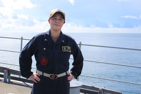 Women in her uniform smiling on the ship