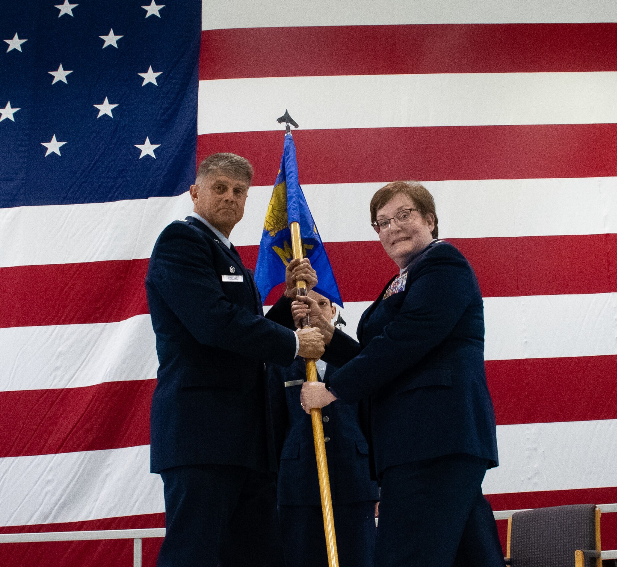 Col. Glenn Collins, 932nd Airlift Wing commander, presents Lt. Col. Amy Johannsen 932nd Maintenance Group commander, with the group guidon during an assumption of command ceremony at Scott Air Force Base, Ill. on March 6.  (U.S. Air Force photo by Maj. Neil Samson)