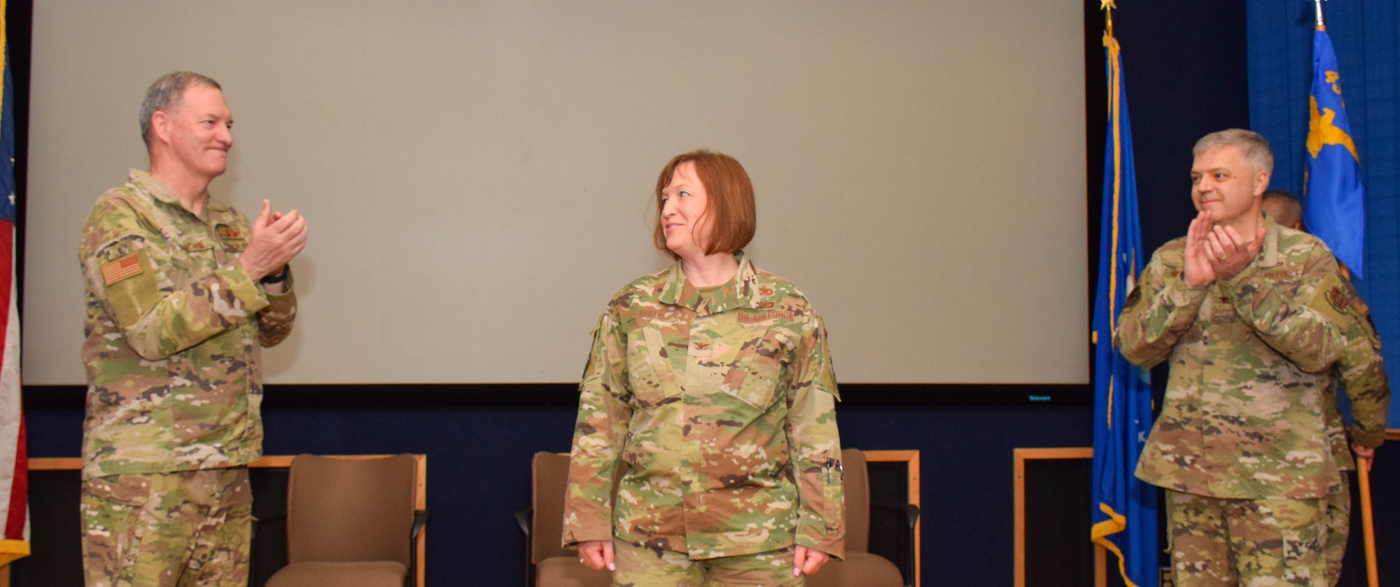 Col. Terry W. McClain, 433rd Airlift Wing commander, Col. Wayne M. Williams, former 433rd Mission Support Group commander, applaud Col. Jeanne E. Bisesi, for taking command of the 433rd MSG during a ceremony at Joint Base San Antonio-Lackland, Texas, March 5, 2022. The ceremony allowed Williams to say farewell and Bisesi to officially greet 433rd MSG personnel under her command. (U.S. Air Force photo by Airman Mark Colmenares)