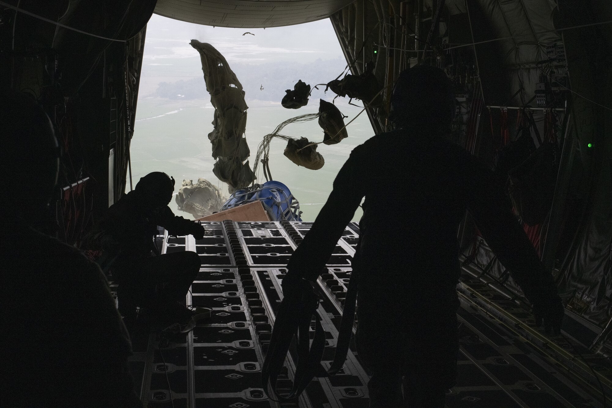 Staff Sgt. McArthur Posey, left, and Tech Sgt. Wesley Zech, right, 36th Expeditionary Airlift Squadron loadmasters, release container delivery systems (CDS) for air drop off the ramp of a C-130J Super Hercules during Exercise Cope South 2022, Feb. 20, 2022, over a drop zone near Sylhet, Bangladesh. Airmen assigned to the 36th EAS worked side-by-side with Bangladesh air force (BAF) pilots and maintainers to perform air drops and low level flying as part of the day’s tasks. Exercise Cope South provides an opportunity for U.S. and Bangladesh forces to strengthen their partnership to enhance their interoperability in efforts to maintain regional stability.