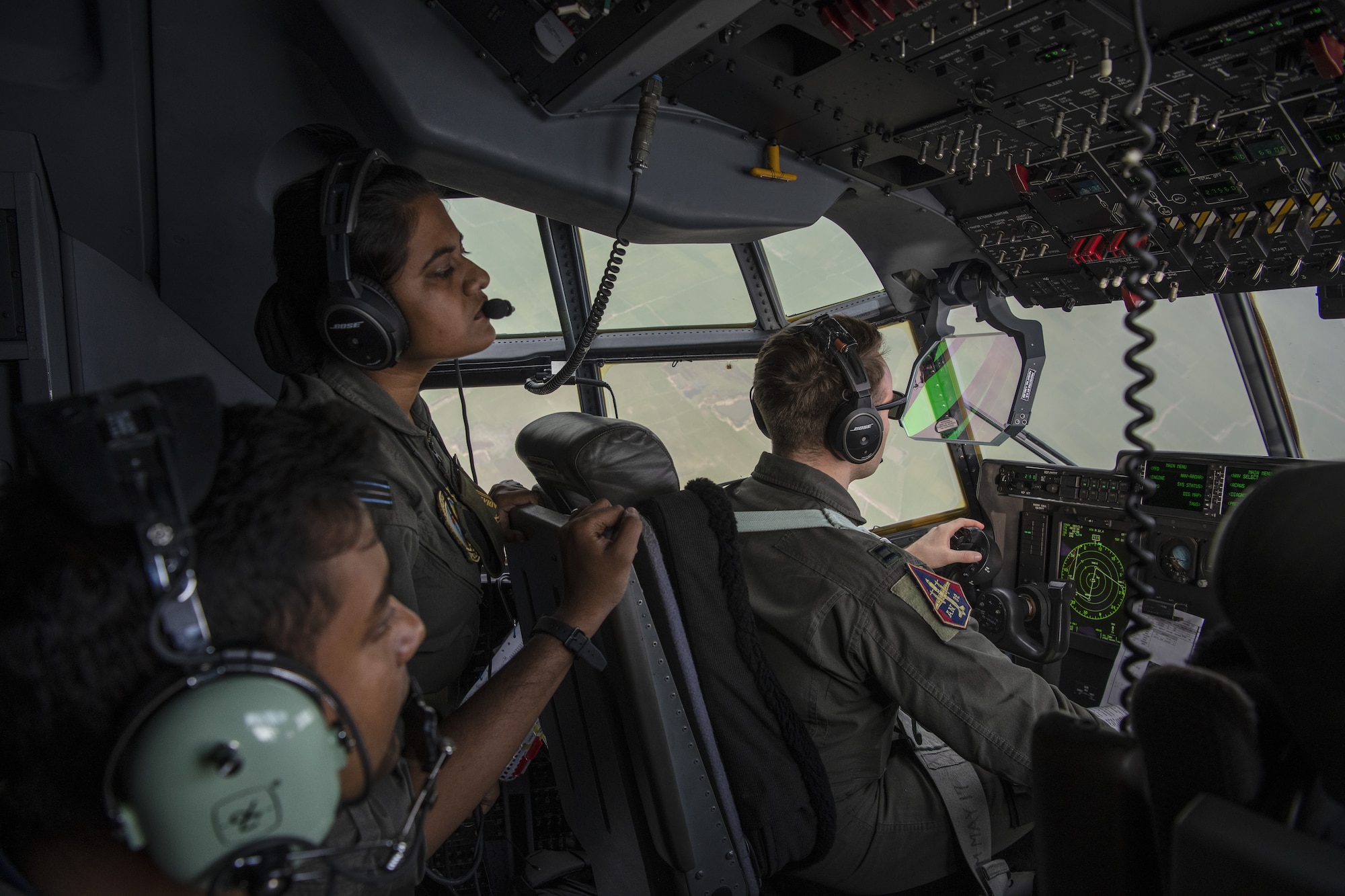 Bangladesh air force (BAF) Squadron Leader Sabbir Rehan, left and BAF Flight Lieutenant Israt Drishty, C-130 Hercules pilots, observe a low level flying demonstration conducted by U.S. Air Force C-130J Super Hercules pilots assigned to the 36th Expeditionary Airlift Squadron during Exercise Cope South 2022, Feb. 20, 2022, over Bangladesh. Airmen assigned to the 36th EAS work side-by-side with BAF pilots and maintainers to perform training tasks and evaluate proficiency during the exercise. Exercise Cope South provides an opportunity for U.S. and Bangladesh forces to strengthen their partnership to enhance their interoperability in efforts to maintain regional stability.