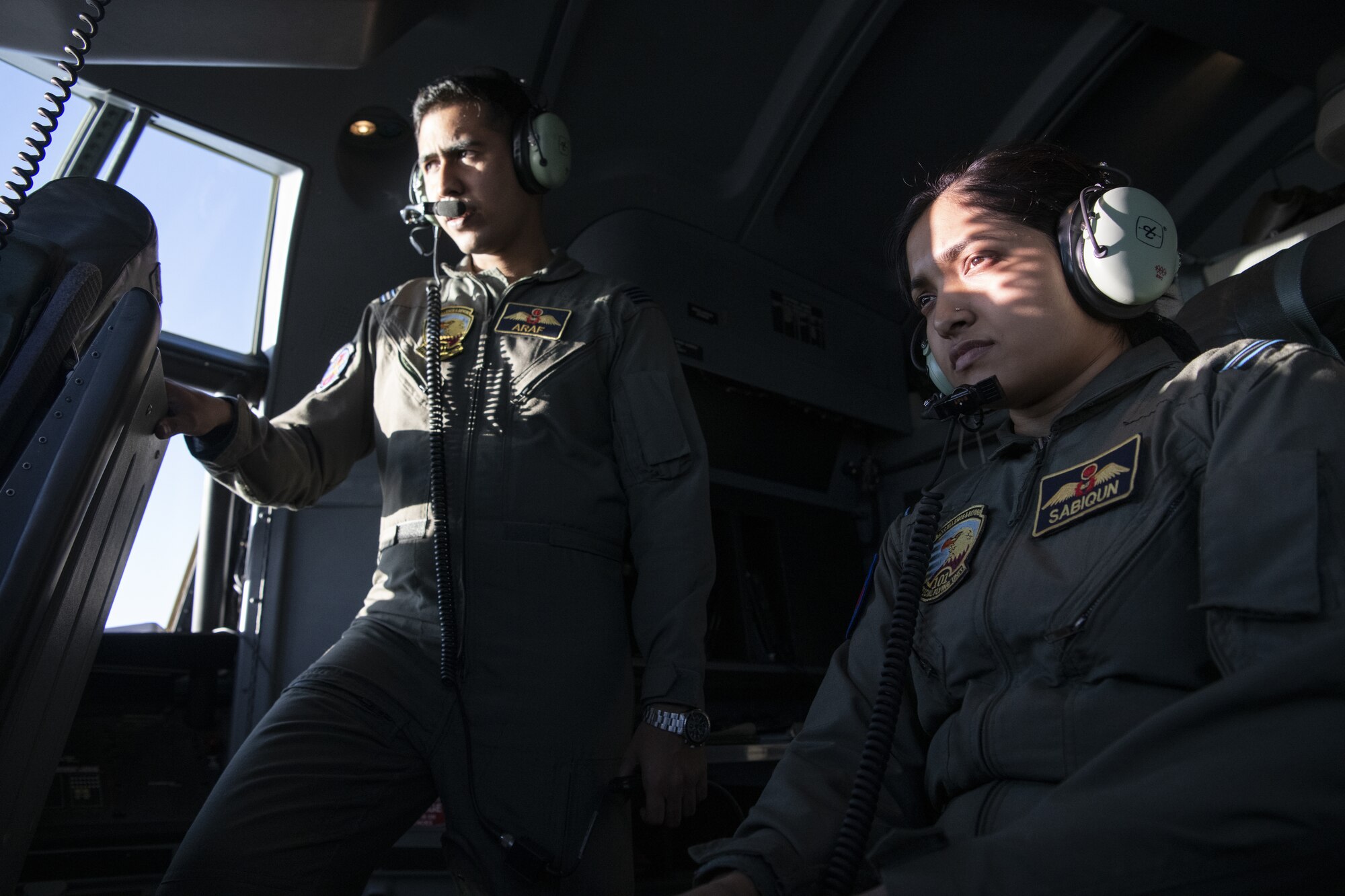 Flight Lieutenant Araf Billah, left, and Flight Lieutenant Sabiqun Nahar Chodhury, right, Bangladesh air force (BAF) C-130 Hercules pilots, observe U.S. Air Force pilots assigned to the 36th Expeditionary Airlift Squadron, as they pilot a C-130J Super Hercules during Exercise Cope South 2022, Feb. 22, 2022, over Bangladesh. U.S. and Bangladesh air forces (BAF) conducted static line and high altitude, low opening (HALO) jumps during the exercise. The bilateral exercise provides an opportunity for Pacific Air Forces and the BAF to strengthen their relationship and enhance interoperability, to operate more effectively together when needed.