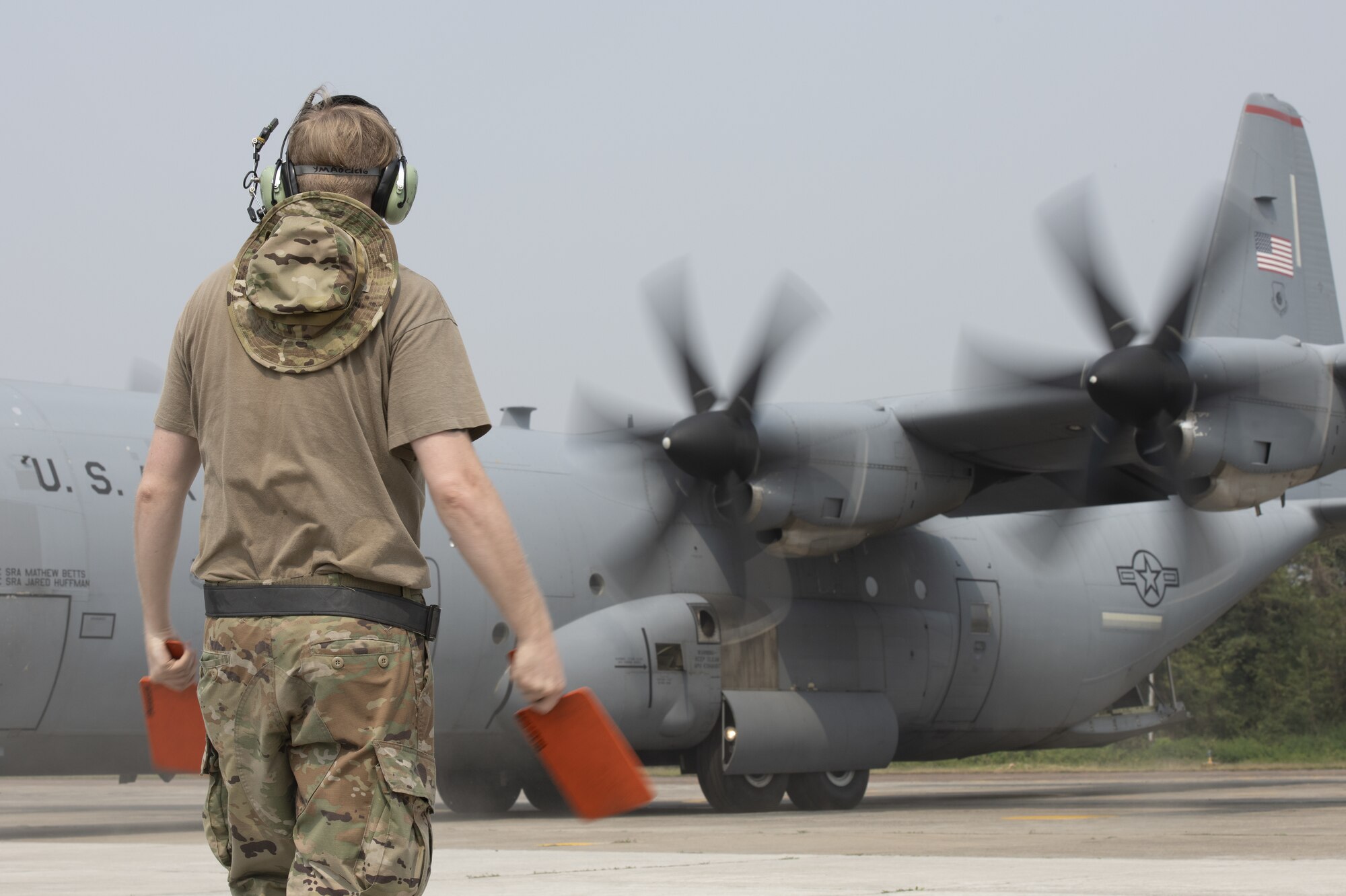Senior Airman Logan Nawrocki, 36th Expeditionary Airlift Squadron integrated communication navigation mission systems and electronic warfare journeyman, marshals a C-130J Super Hercules during Exercise Cope South 2022, at Bangladesh Air Force (BAF) Base Bangabandhu, Bangladesh. U.S. Air Force and BAF participants conducted static line and high altitude, low opening (HALO) jumps, low level flying, and night flights during the exercise to enhance their interoperability. Exercise Cope South is a bi-annual Pacific Air Forces-sponsored bilateral exercise that provides U.S. and Bangladesh air forces the opportunity to work together while performing tactical airlift scenarios.