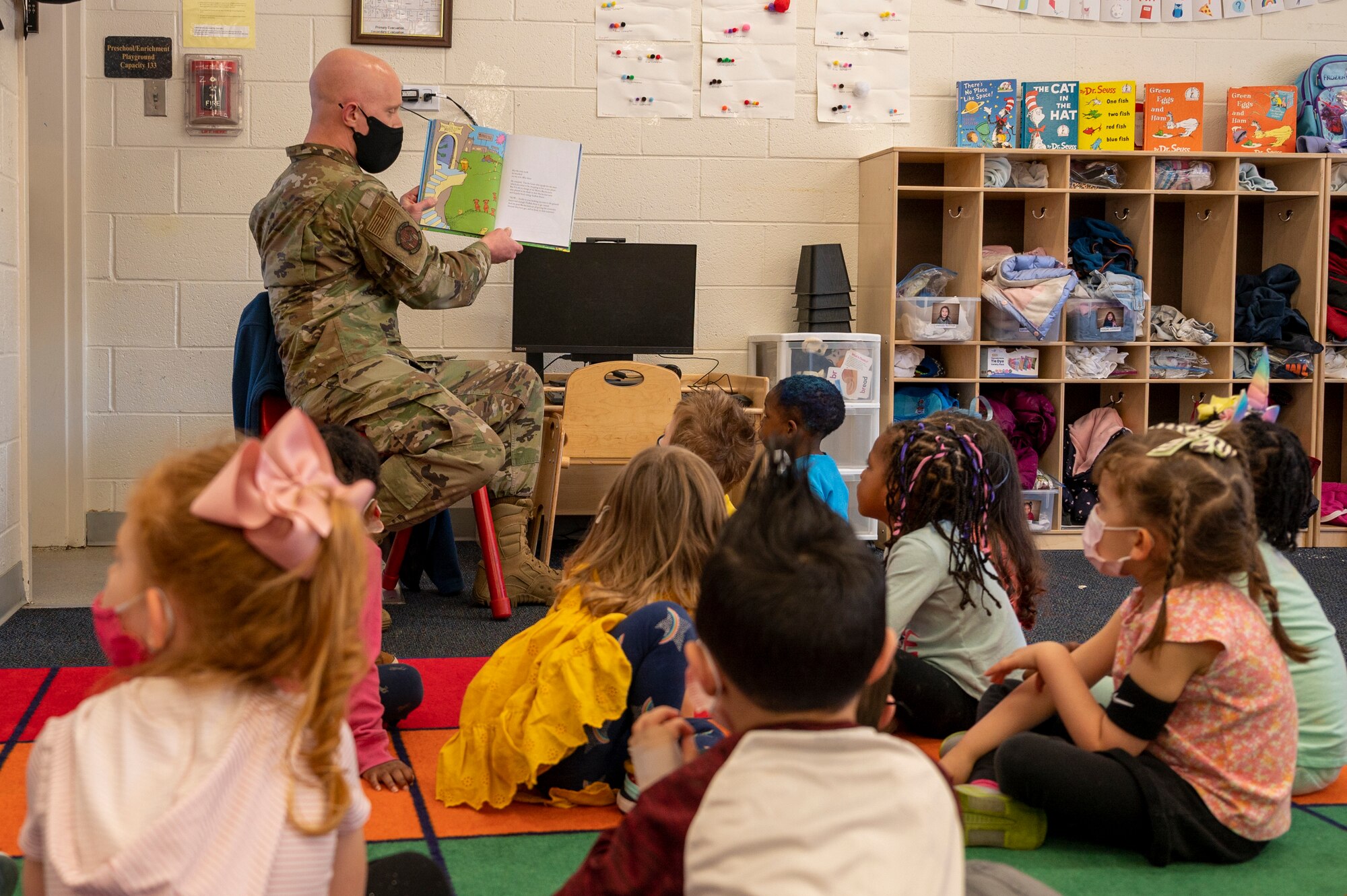 Master Sgt. James Holgerson, 4th Communications Squadron first sgt., reads to students at the Child Development Center at Seymour Johnson Air Force Base, North Carolina, March 2, 2022.