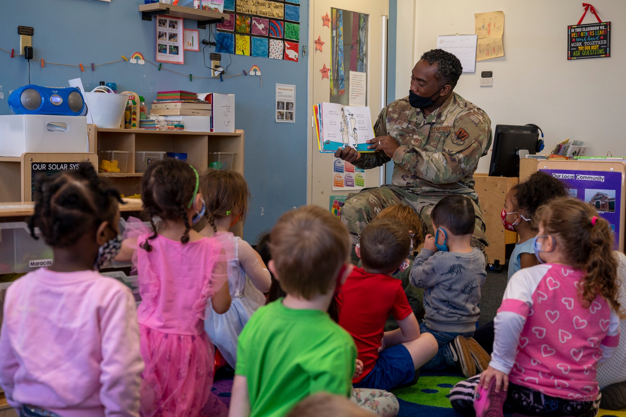 Master Sgt. Leonard Collins, 4th Comptroller Squadron first sgt., reads to students at the Child Development Center at Seymour Johnson Air Force Base, North Carolina, March 2, 2021.