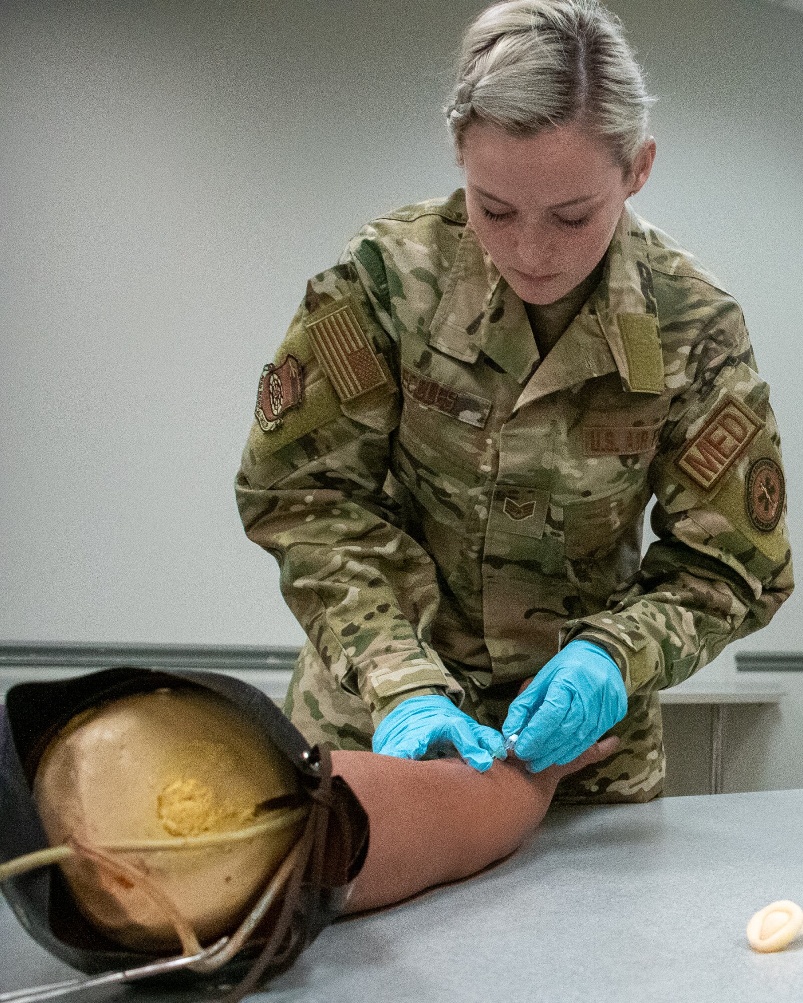 Staff Sgt. Abby Eccles, 932nd Medical Squadron medical technician, practices with an intravenous needle on the arm of a medical mannequin in preparation for a March Unit Training Assembly (UTA) medical exercise.  As a medical technician, she is a valuable, multi-faceted healthcare team member, augmenting other medical professionals to provide critical support and essential care in multiple medical roles, assisting doctors and care for patients in a wide range of situations, ranging from administering immunizations to supporting aeromedical evacuation operations.