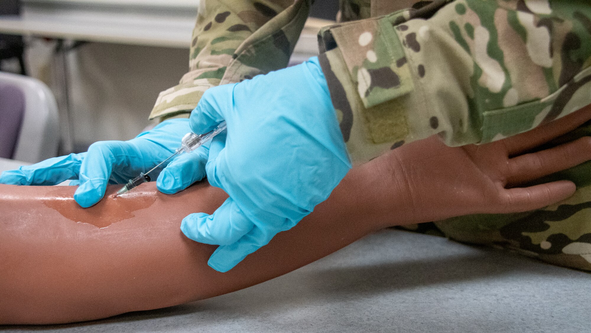 Staff Sgt. Abby Eccles, 932nd Medical Squadron medical technician, practices with an intravenous needle on the arm of medical mannequin in preparation for a March Unit Training Assembly (UTA) medical exercise.  Eccles' AF Reserve career applies conversely to both her undergraduate degree and civilian career as a phlebotomist.