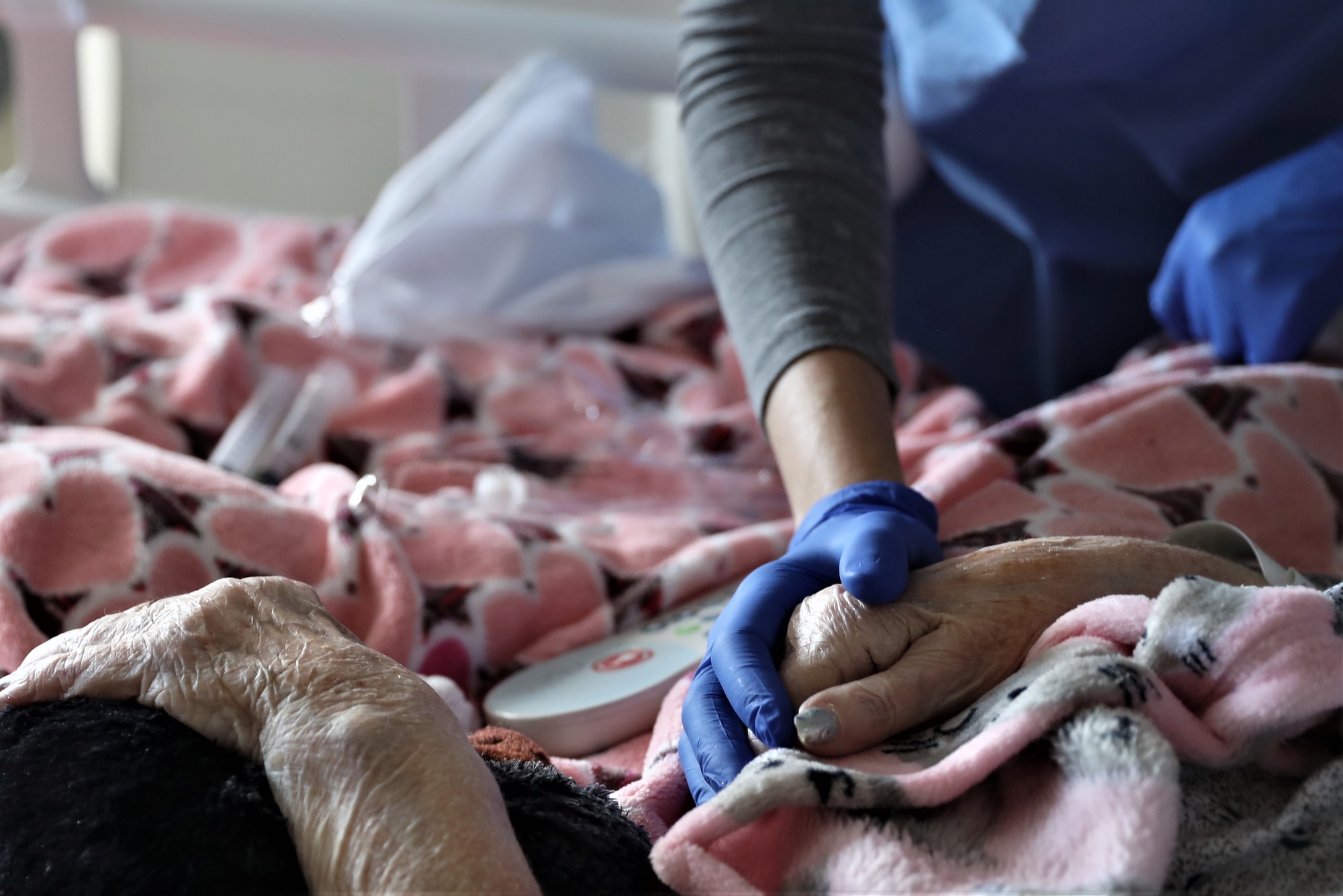 nurse holding patients hand