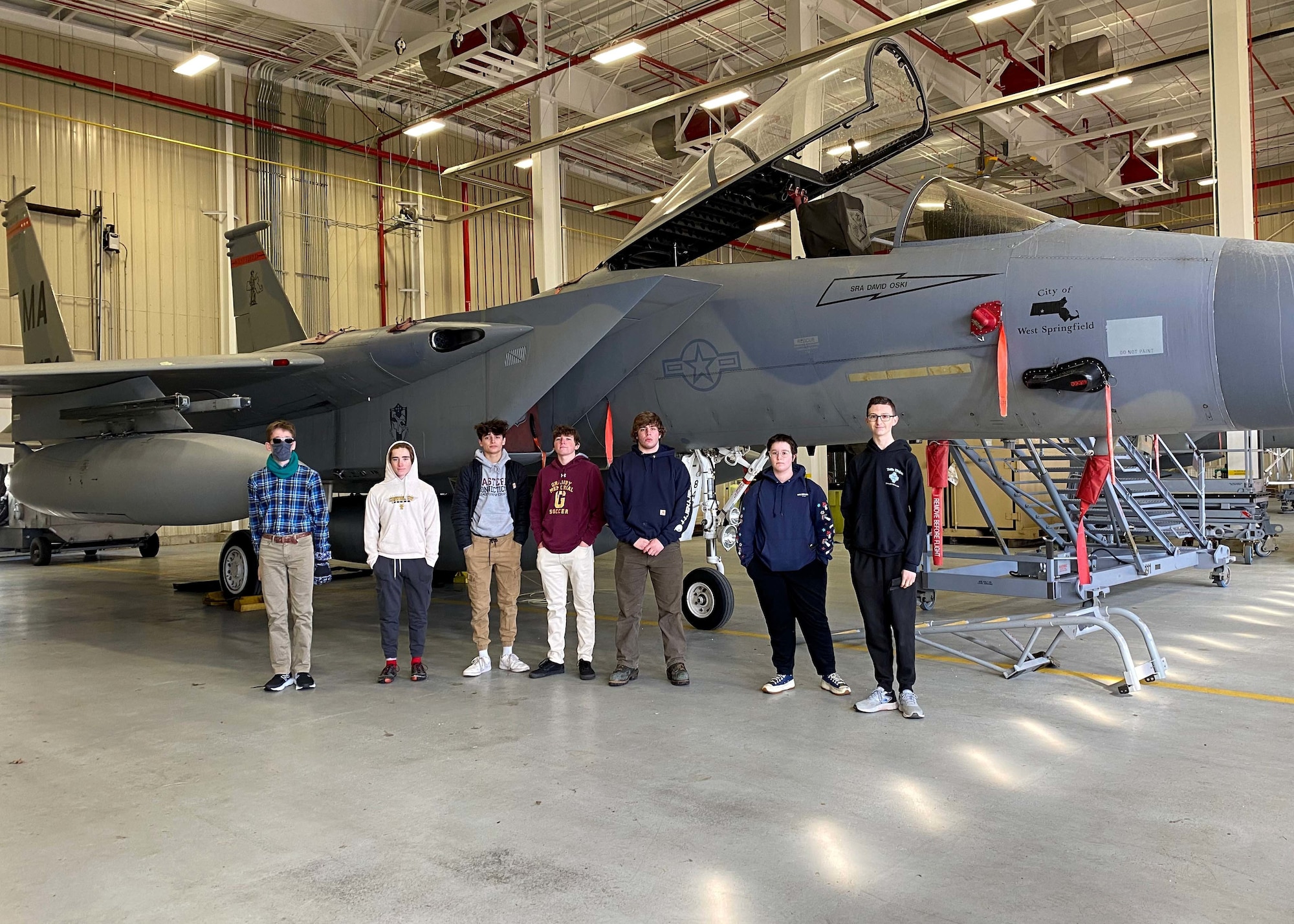 The 104th Fighter Wing hosts students from Granby Memorial High School showing interest in joing the National Guard. Students pose for a photo in front of a static F-15. Students were told about the importance in the maintenance of the F-15s. (U.S. Air National Guard courtesy photo)