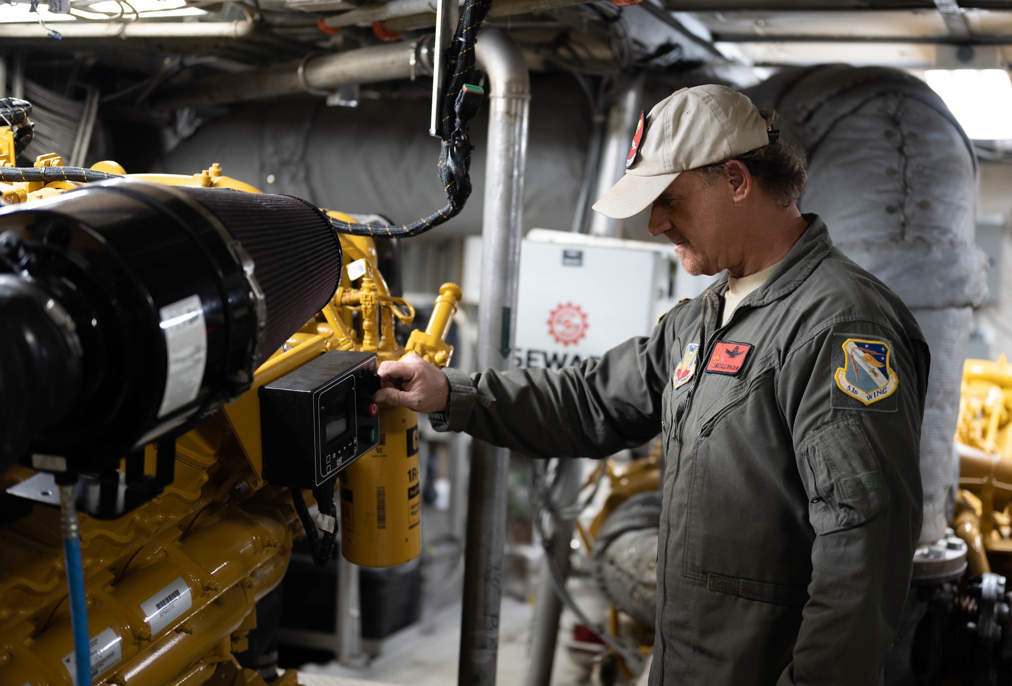 A government employee touches an engine of a missile retriever boat