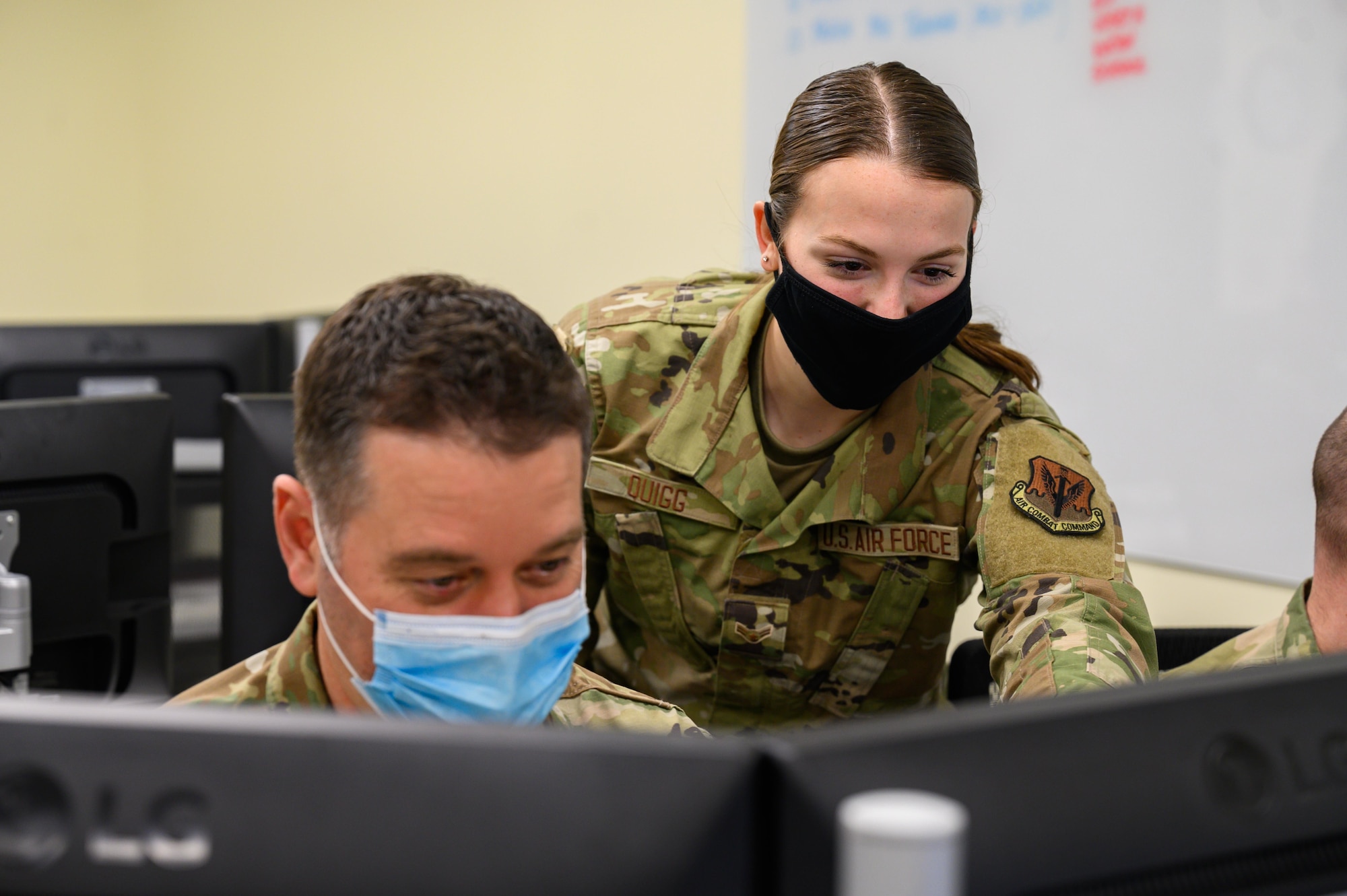 (From left) Tech Sgt. Jonathan Digges, a cyber systems operator for the 135th Intelligence Squadron, Maryland Air National Guard, works on a computer with Airman 1st Class Elizabeth Quigg, a fusion analyst for the 135th IS, MDANG, on Feb. 12, 2022, at Warfield Air National Guard Base at Martin State Airport, Middle River, Maryland.  (U.S. Air National Guard photo by Staff Sgt. Sarah M. McClanahan)