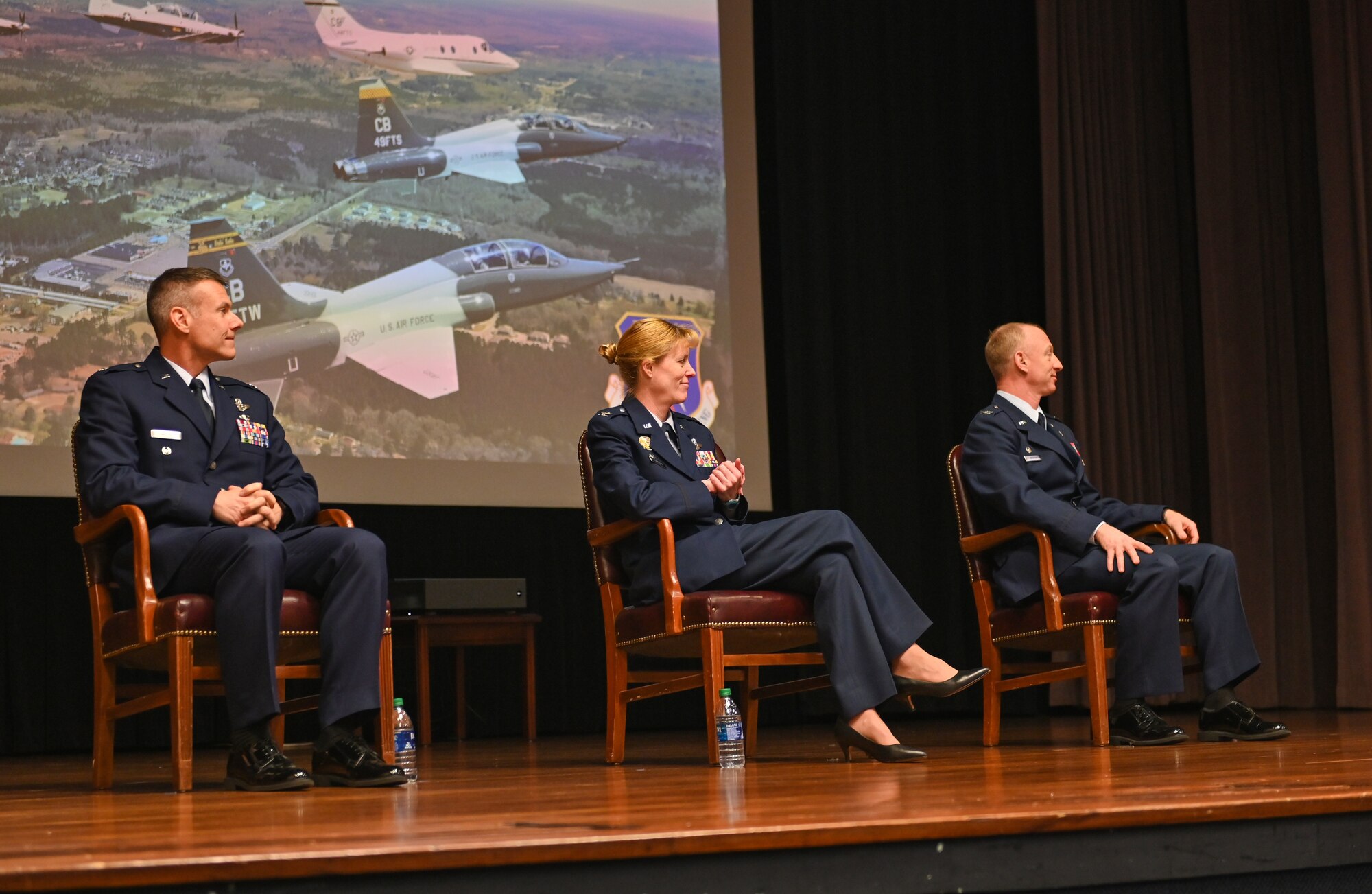 U.S. Air Force Col. Seth Graham (Right), 14th Flying Training Wing commander, U.S. Air Force Col. Kristen Thompson (Middle) 55th Wing commander, and U.S. Air Force Lt. Col. Nathaniel Wilds (Left), 50th Flying Training Squadron commander, sit at Specialized Undergraduate Pilot Training Class 22-06’s graduation on March 4, 2022, at Columbus Air Force Base, Miss. The SUPT graduates accomplished a 52-week training program. (U.S. Air Force photo by Senior Airman Davis Donaldson)