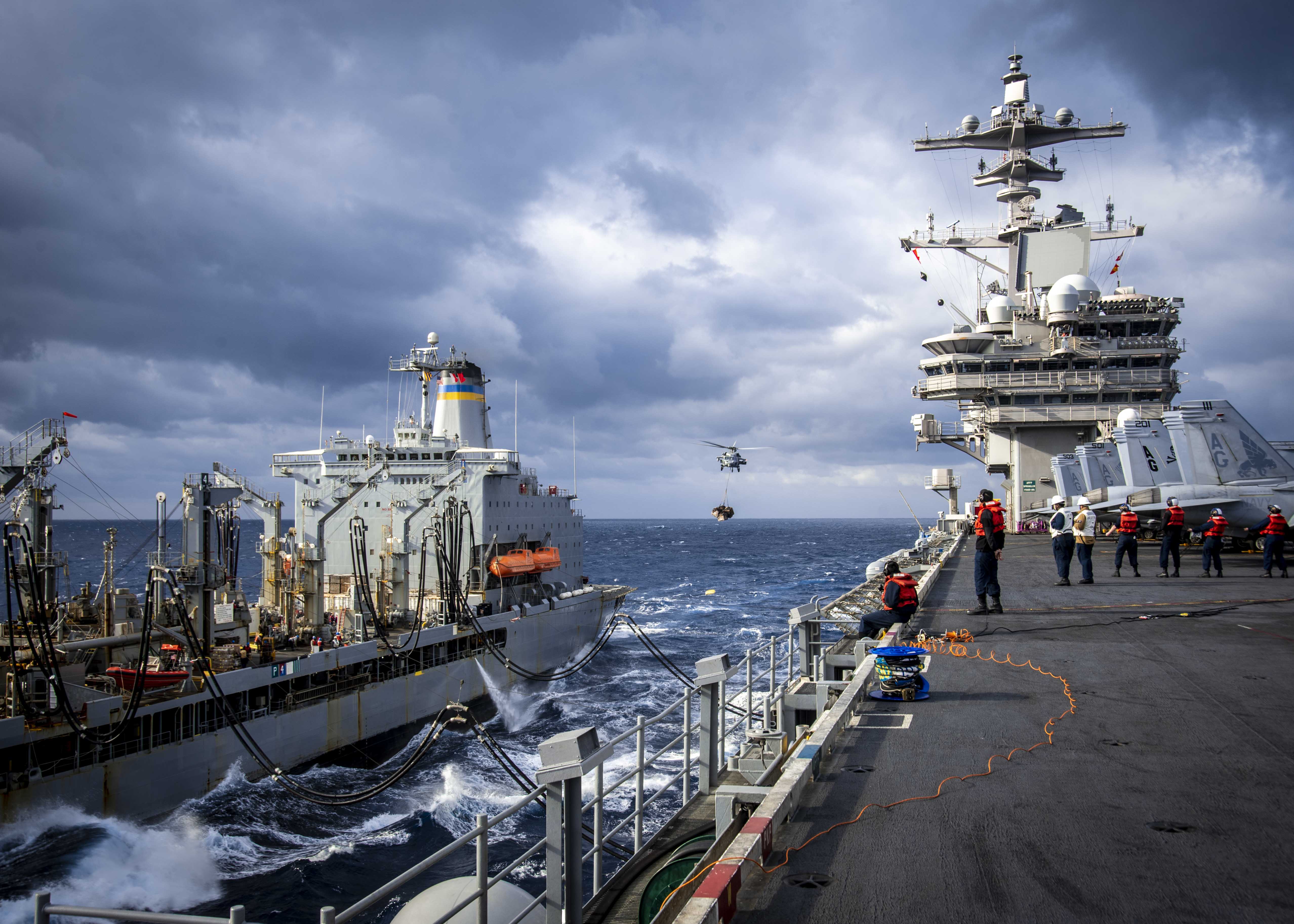 The aircraft carrier USS George H.W. Bush (CVN 77) sails beside the Military Sealift Command replenishment oiler USNS John Lenthall (T-AO-189) during a replenishment-at-sea, March 4, 2022.