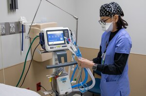 Nurse working at machine