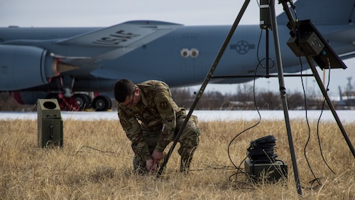 Airman pushing stake into ground with hands