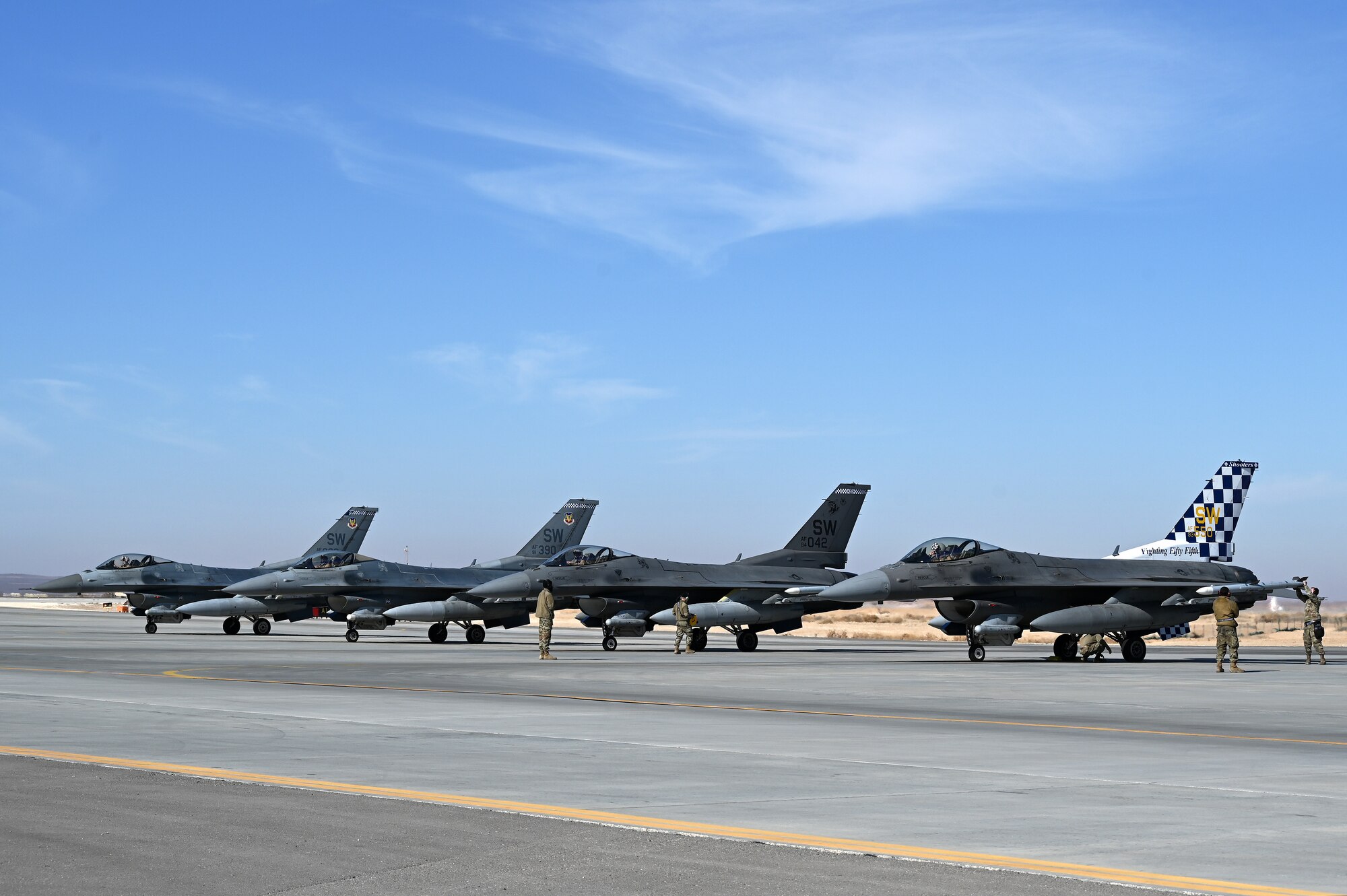 Four 332d Air Expeditionary Wing F-16 Fighting Falcon aircraft wait for armament prior to takeoff in Southwest Asia, Feb. 8, 2022.