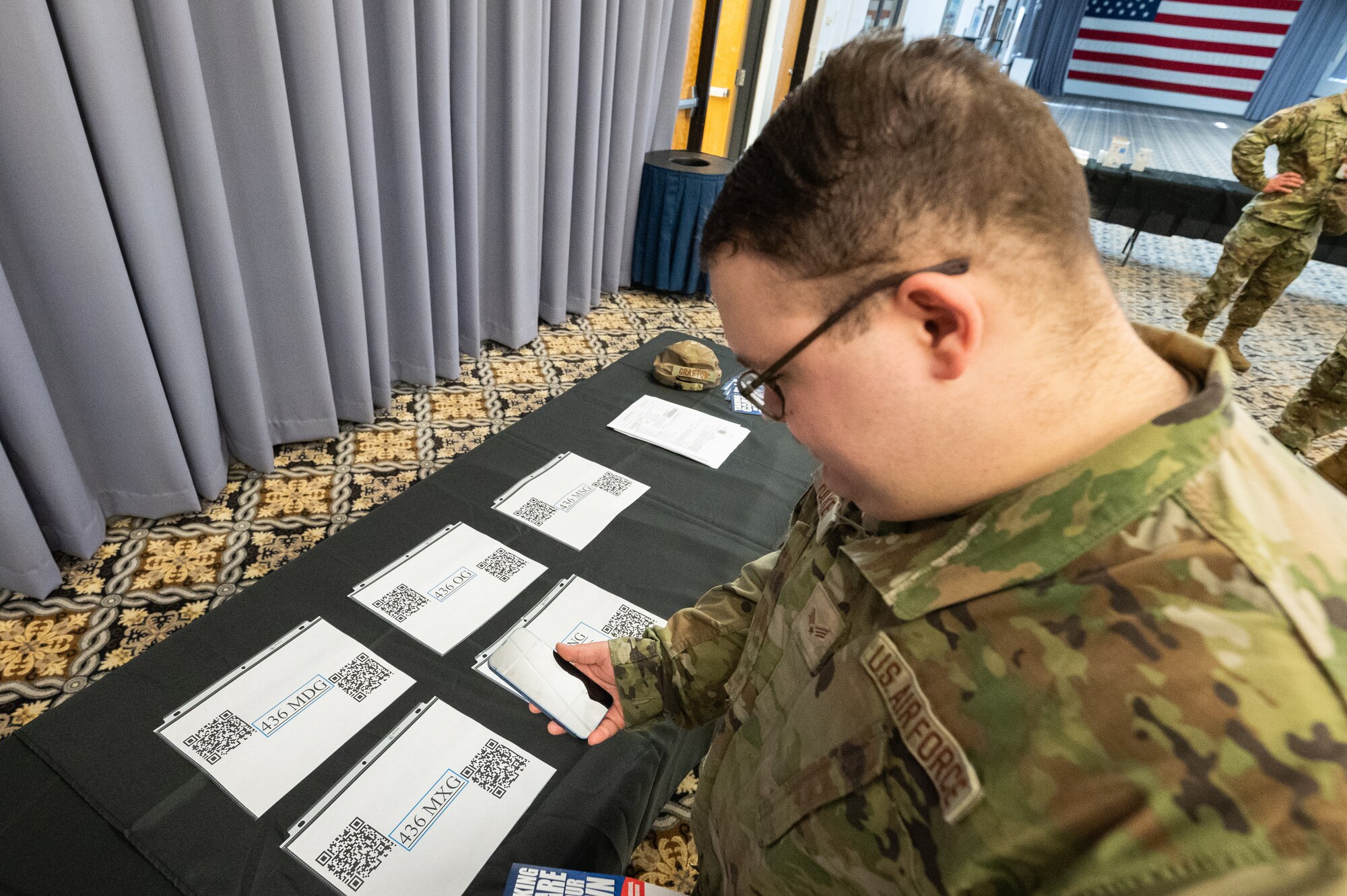 Senior Airman Austin Folkes, 436th Maintenance Squadron aircraft structural maintenance apprentice, makes a donation at the 2022 Air Force Assistance Fund Kickoff event on Dover Air Force Base, Delaware, March 7, 2022. Attendees who wished to donate could scan a QR code leading them straight to their unit’s peer-to-peer site. The AFAF raises money for four charities that take care of Airmen, Guardians and their families. Airmen who wish to donate can reach out to their unit program officer. (U.S. Air Force photo by Mauricio Campino)