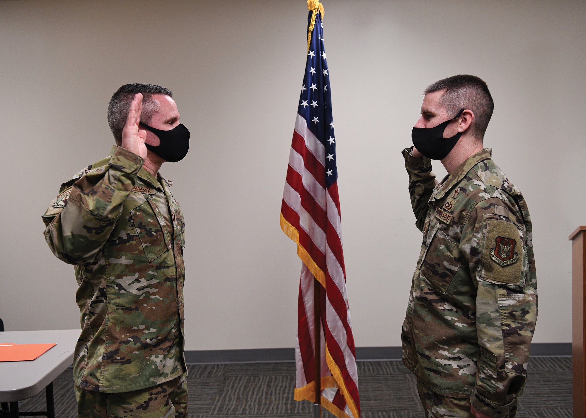 Chaplain (Capt.) Patrick Stalnaker, 445th Airlift Wing Chaplain Corps, administers the Oath of Office to 1st Lt. Darrell Hornback during a commissioning ceremony Feb. 16, 2022.