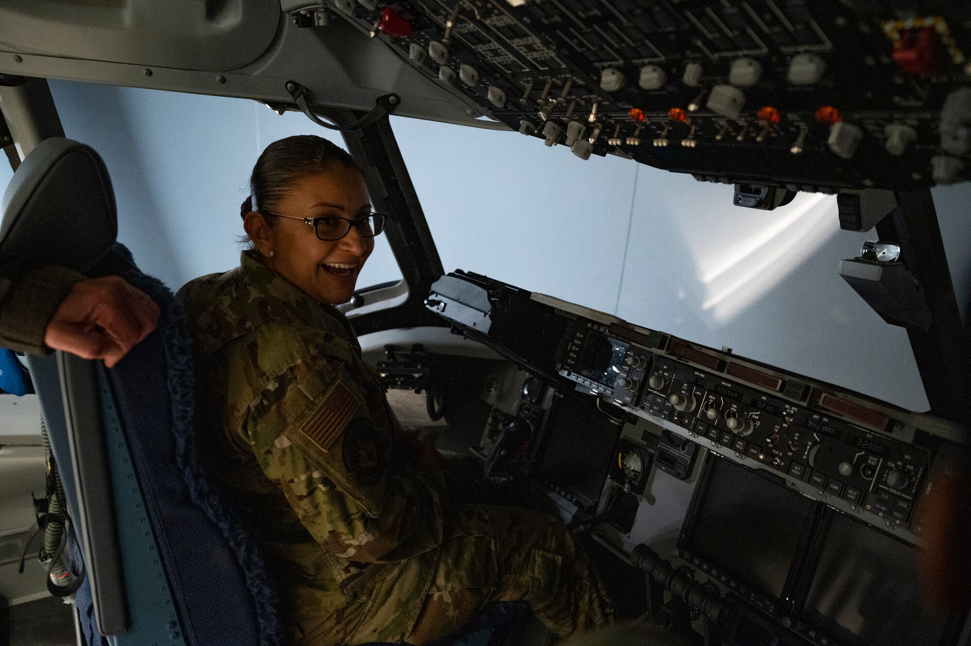 Chief Master Sgt. Cynthia Villa, 4th Air Force command chief, sits in the pilot seat of a flight simulator at the Pittsburgh International Airport Air Reserve Station, Pennsylvania, March 6, 2022.