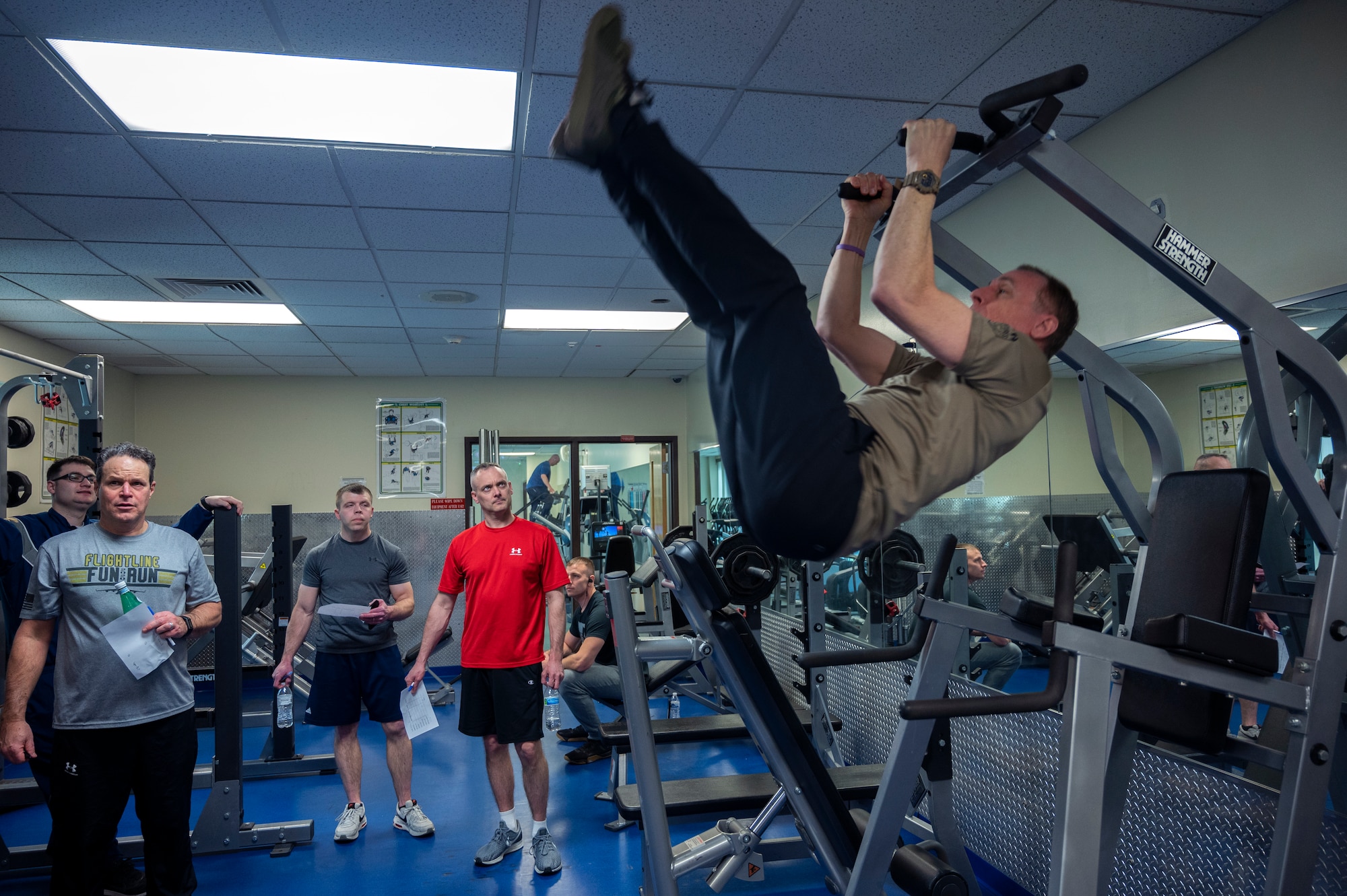 Tim Murphy, Founder and Clinical Director of Fortis Future, performs a form of toes to bar exercises at the Pittsburgh International Airport Air Reserve Station, Pennsylvania, March 5, 2022.