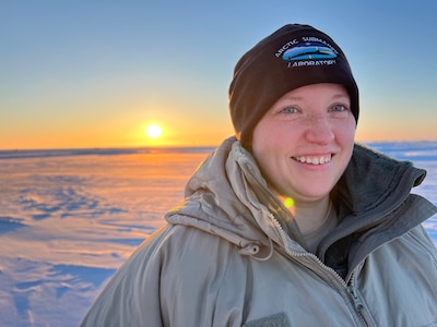 Lt. Colleen Wilmington, assigned to the Naval Ice Center (NAVICE) in Suitland, Maryland, is pictured outside an airplane hangar in Prudhoe Bay, Alaska. Wilmington is serving as the officer in charge of a four-person meteorological team from NAVICE and Strike Group Oceanography Team (SGOT) Norfolk supporting the U.S. Navy’s Ice Exercise (ICEX) 2022.