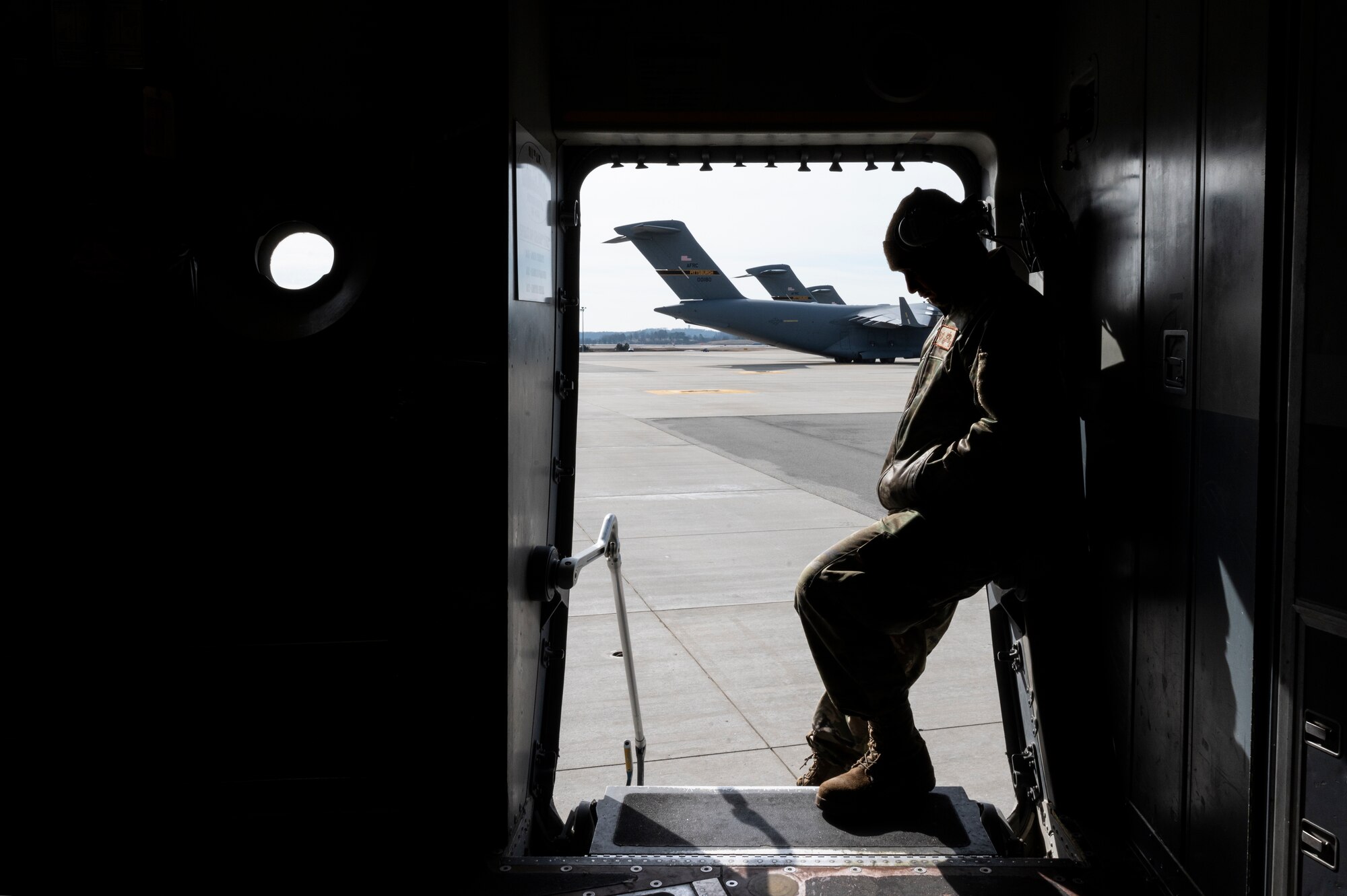 An Airman assigned to the 911th Airlift Wing waits to start his portion of a pre-flight inspection on a C-17 Globemaster III at the Pittsburgh International Airport Air Reserve Station, Pennsylvania, March 1, 2022.