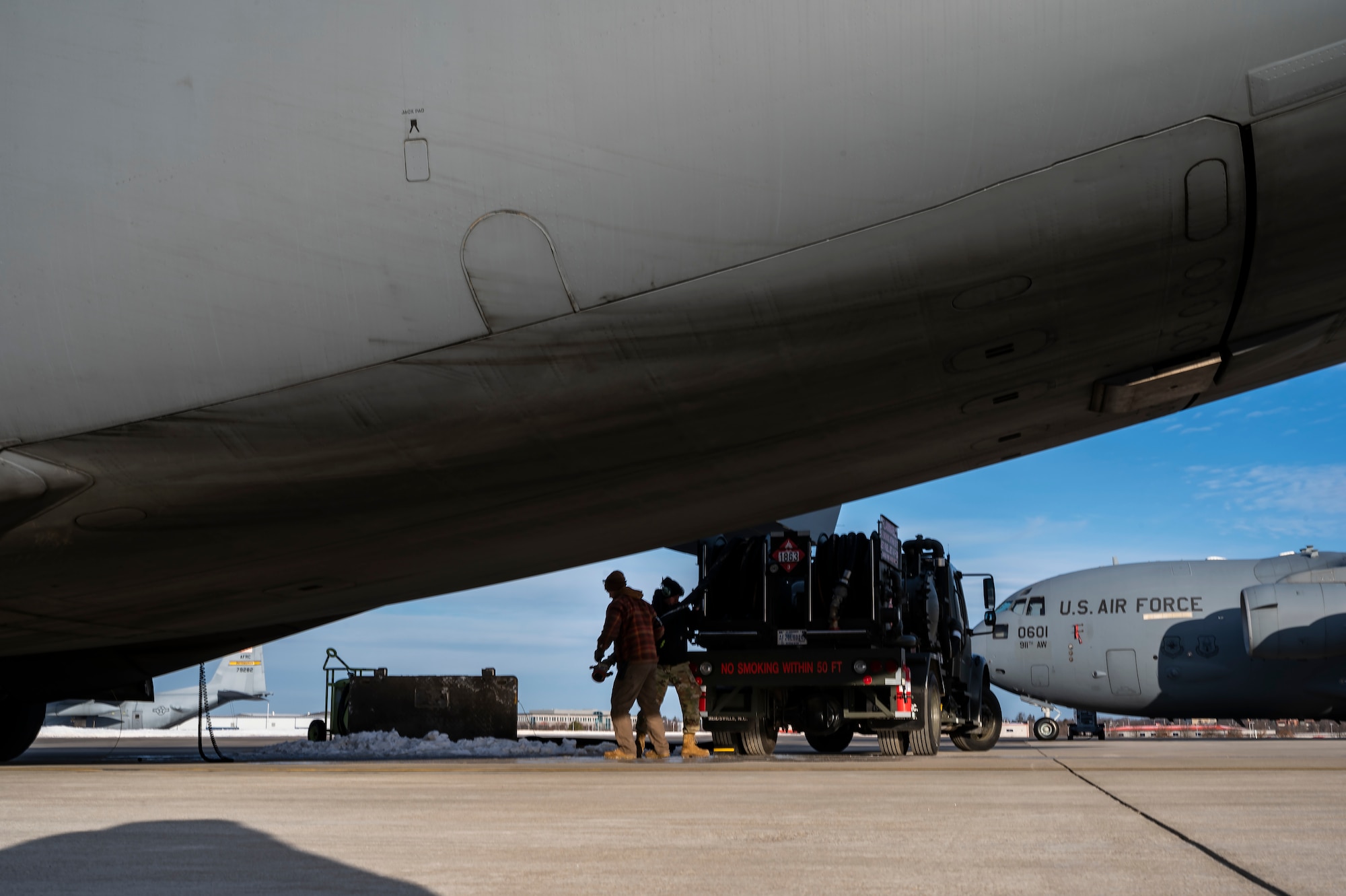 Airmen assigned to the 911th Airlift Wing prepare to fuel a C-17 Globemaster III at the Pittsburgh International Airport Air Reserve Station, Pennsylvania, Feb. 9, 2022.