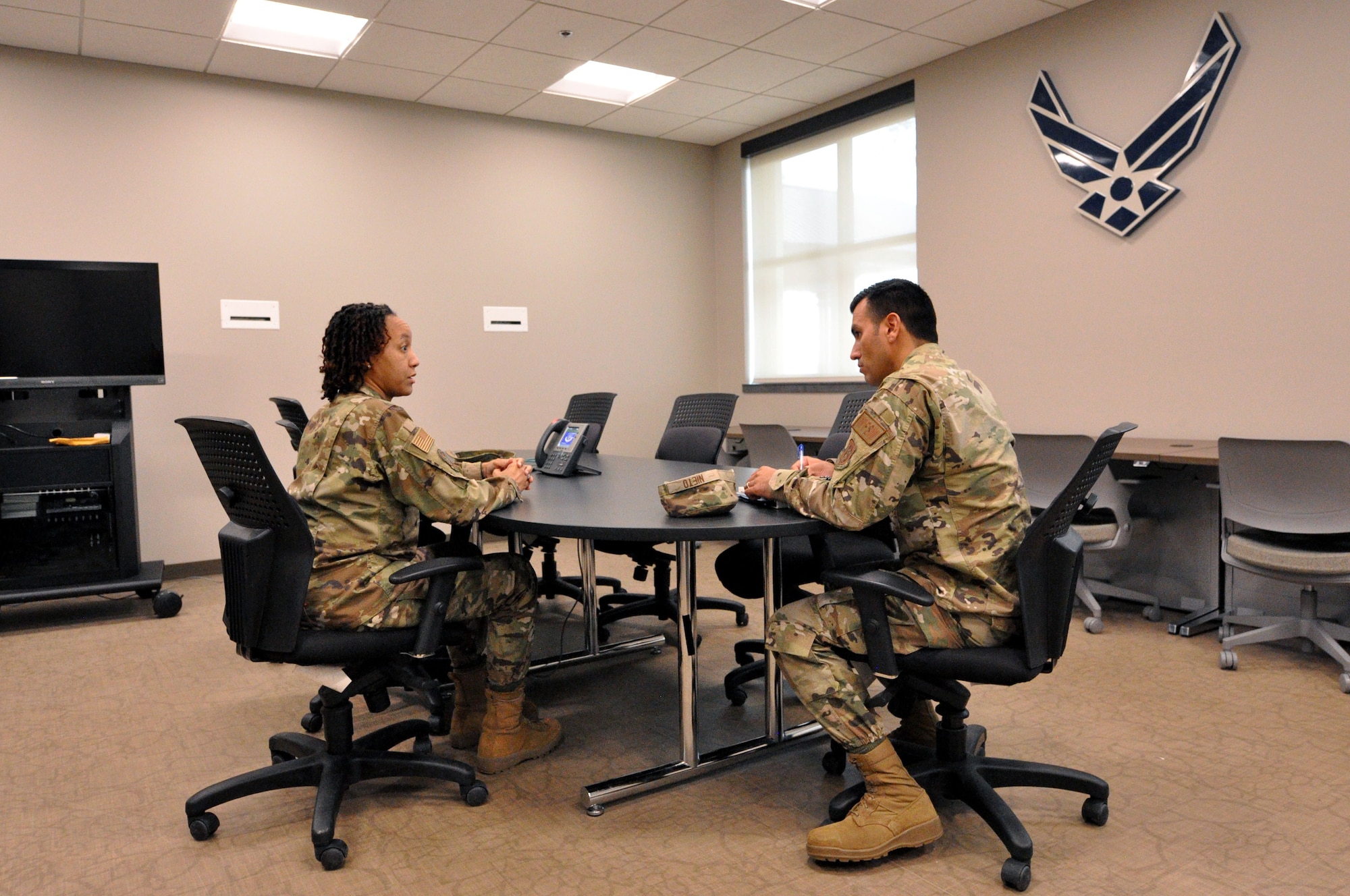 Senior Master Sgt. Traci Taylor, 301st Fighter Wing Education and Training specialist, and Airman 1st Class Emanuel Nieto, 301 FW Water and Fuel Systems Maintenance specialist, meet in the Education and Training Office’s new multi-use computer room in the newly renovated 301 FW headquarters building at Naval Air Station Joint Reserve Base Fort Worth, Texas, March 6, 2022. (U.S. Air Force photo by Staff Sgt. Randall Moose)