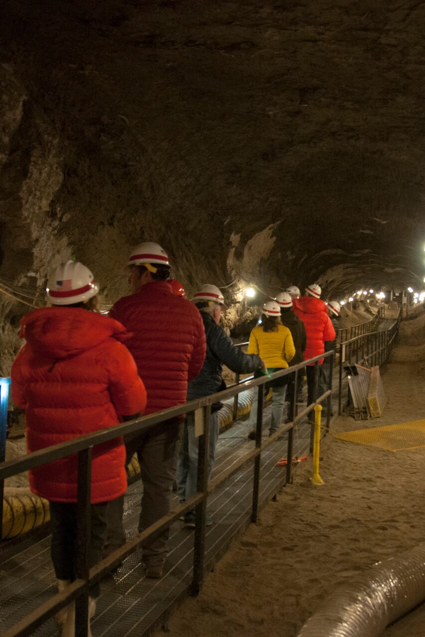 A tour group walks through a permafrost tunnel in Alaska.