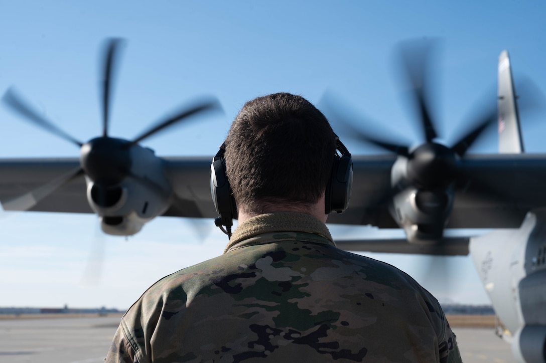 An Airman checks on propellers.