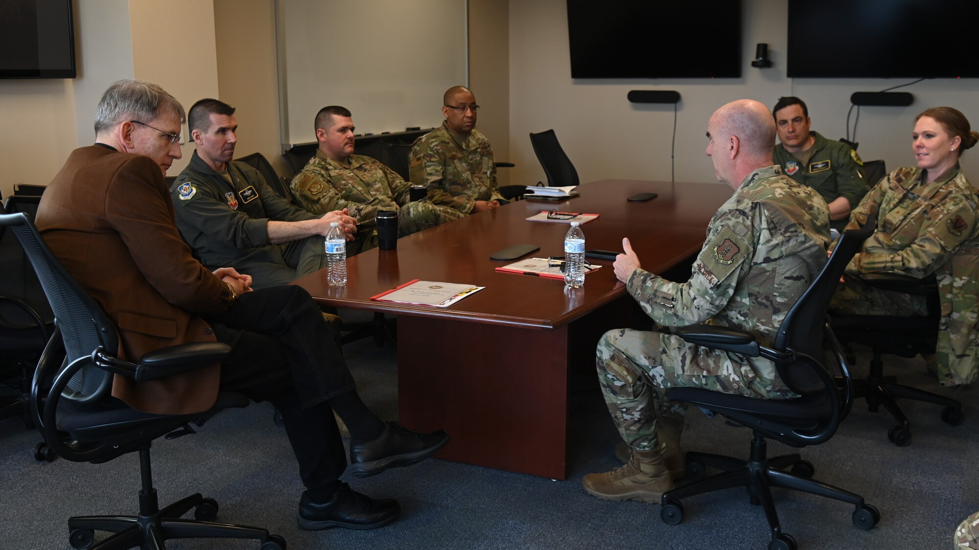 Mr. Devin Cate, (left), executive director, Air National Guard, receives a formal wing briefing from U.S. Air Force Brig. Gen. Edward Jones (right), assistant adjutant general-air, Maryland National Guard, March 5, 2022, during a visit to Warfield Air National Guard Base at Martin State Airport, Middle River, Maryland.  In addition to the briefing, Mr. Cate toured the base and had the opportunity to meet with Airmen and tour the facilities for the maintenance group, mission support group, and the cyberspace operations group. (U.S. Air National Guard photo by A1C Alexandra Huettner)