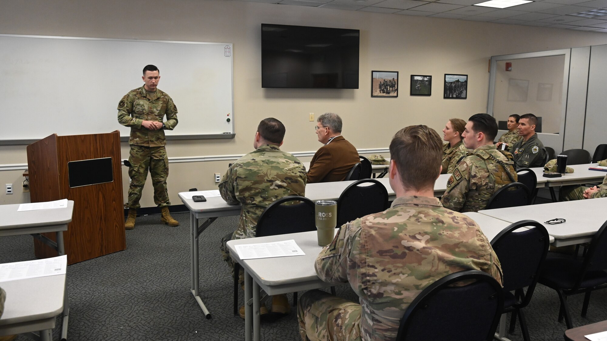 U.S. Air Force Maj. Zachary Blades, left, 175th Wing Security Forces Squadron commander, briefs Mr. Devin Cate, center front, executive director, Air National Guard, March 5, 2022, during a visit to Warfield Air National Guard Base at Martin State Airport, Middle River, Maryland.  Blades discussed the role of security forces at the 175th Wing and their vitality to the mission.  (U.S. Air National Guard photo by A1C Alexandra Huettner)