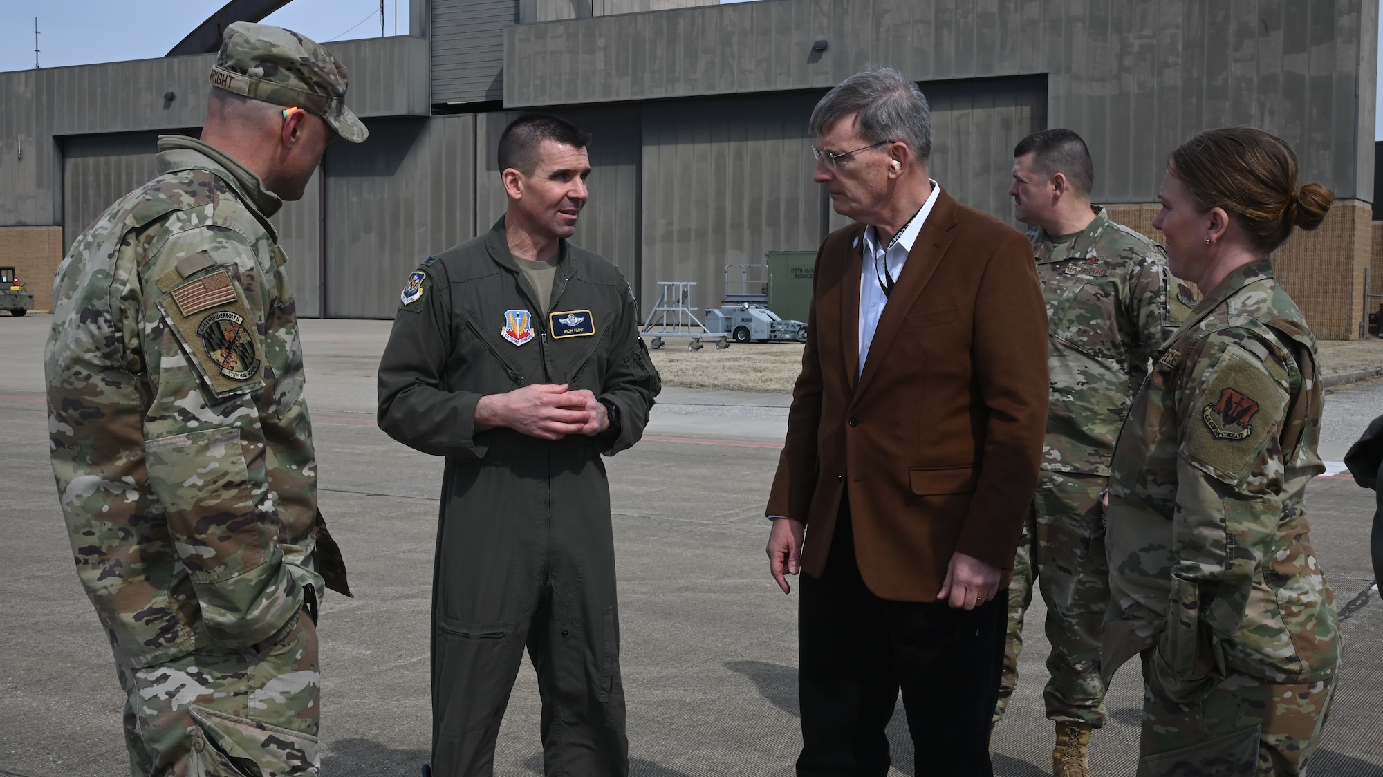 Mr. Devin Cate, center, executive director, Air National Guard, speaks with U.S. Air Force Col. Richard Hunt, (center left), 175th Wing vice commander, on March 5, 2022, during a visit to Warfield Air National Guard Base at Martin State Airport, Middle River, Maryland.  During the tour Cate visited the flightline where he had the opportunity to observe Airmen working as A-10C Thunderbolt IIs landed.  (U.S. Air National Guard photo by A1C Alexandra Huettner)