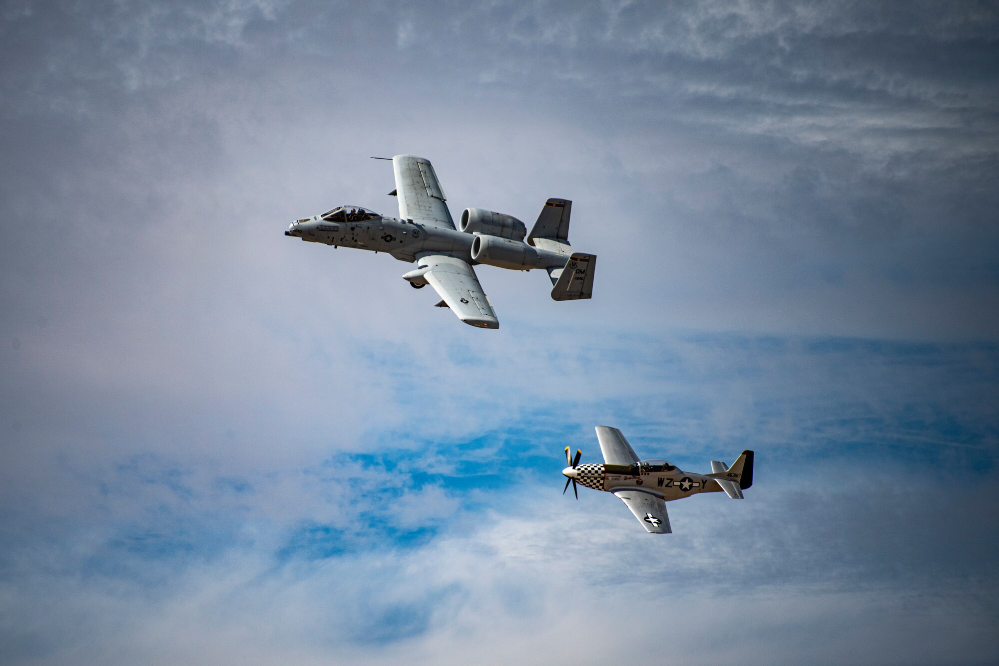 Two planes fly in formation.