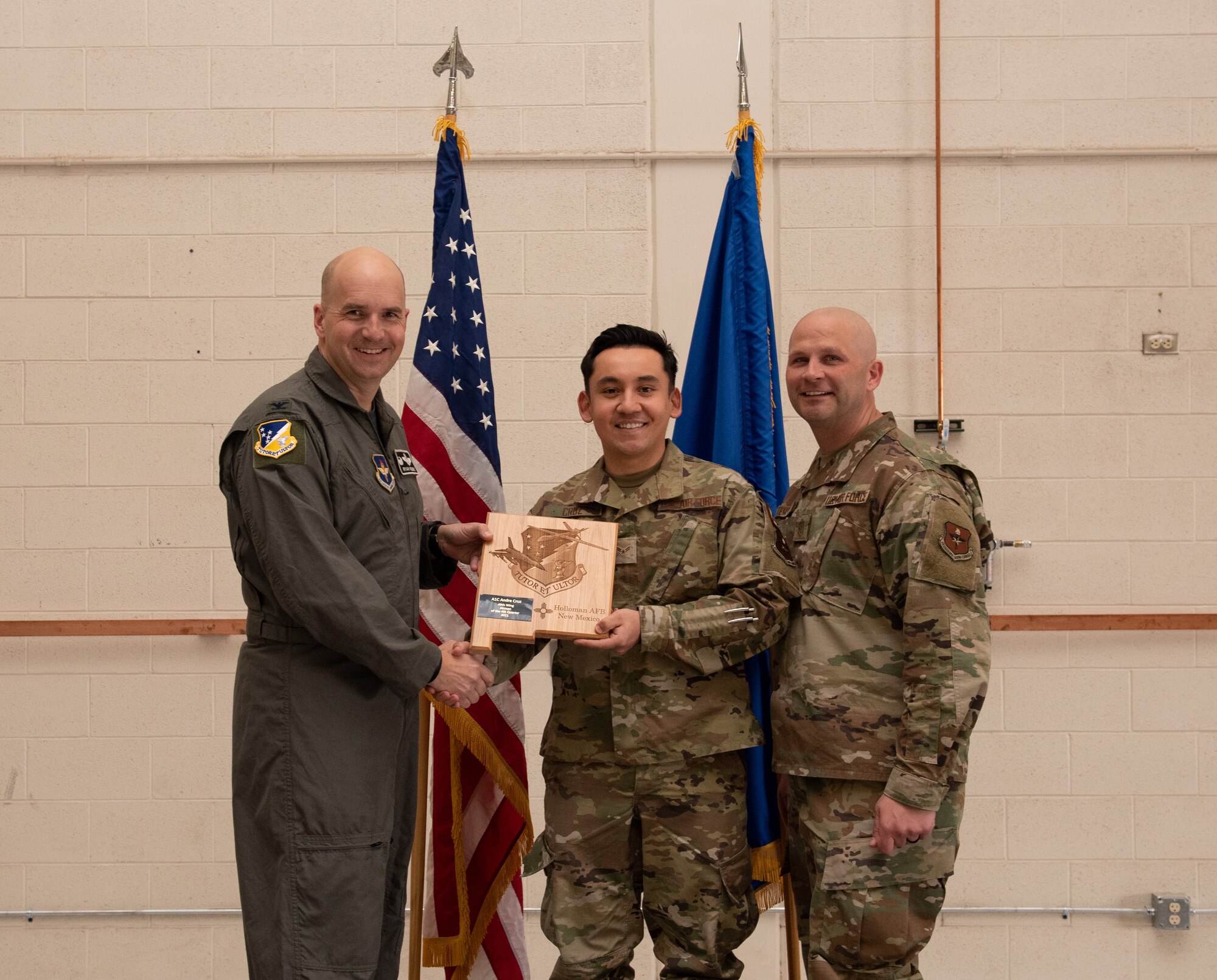 Airman 1st Class Andre Cruz, 49th Maintenance Group quarterly award winner, accepts the 49th Wing Airman of the quarter award during the 49th Wing’s 4th quarter award ceremony, March 4, 2022, on Holloman Air Force Base, New Mexico. Quarterly award winners were selected based on their technical expertise, demonstration of leadership and job performance. (U.S. Air Force photo by Airman 1st Class Nicholas Paczkowski)