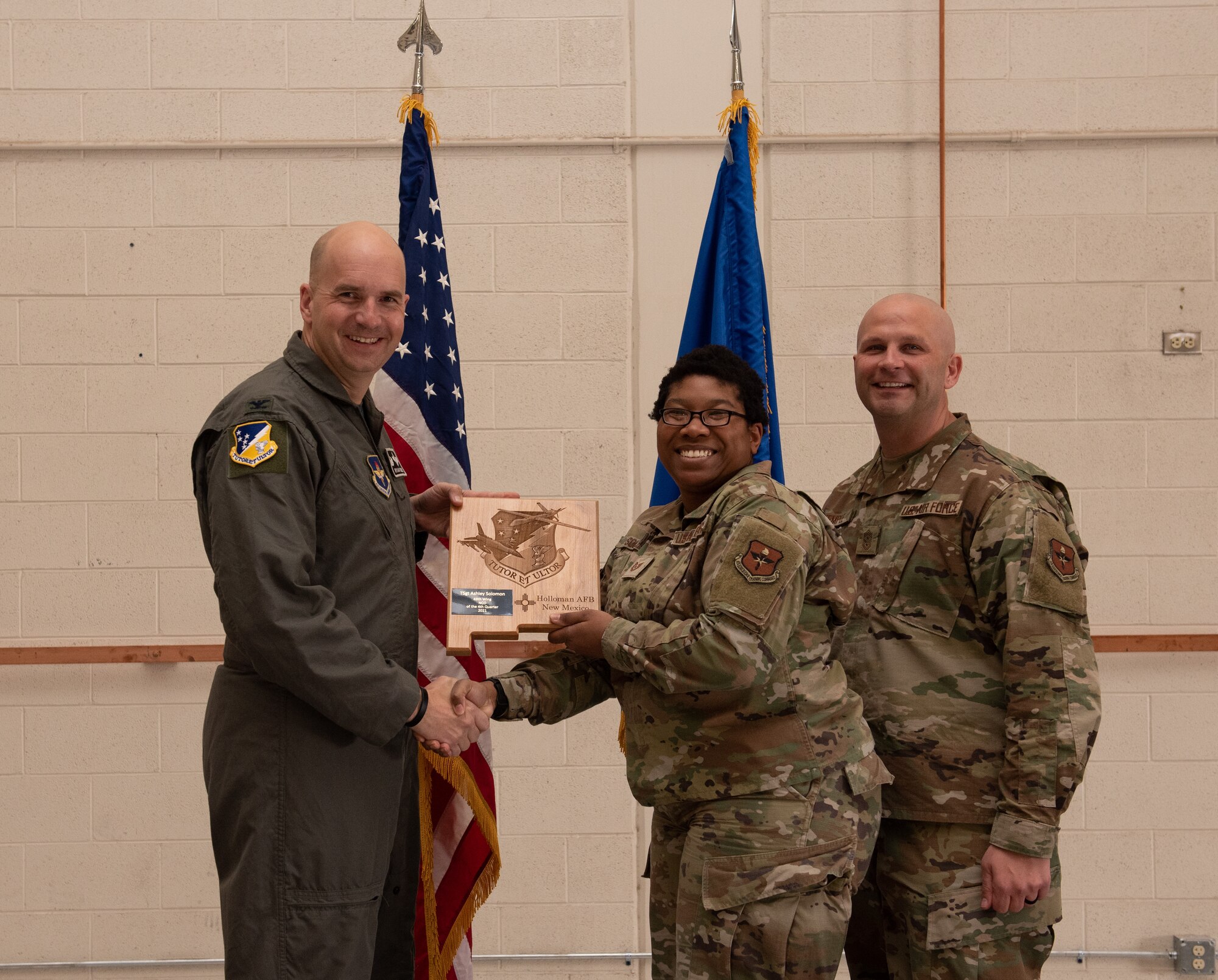 Tech. Sgt. Ashley Solomon, 49th Medical Group quarterly award winner, accepts the 49th Wing Noncommissioned Officer of the quarter award during the 49th Wing’s 4th quarter award ceremony, March 4, 2022, on Holloman Air Force Base, New Mexico. Quarterly award winners were selected based on their technical expertise, demonstration of leadership and job performance. (U.S. Air Force photo by Airman 1st Class Nicholas Paczkowski)